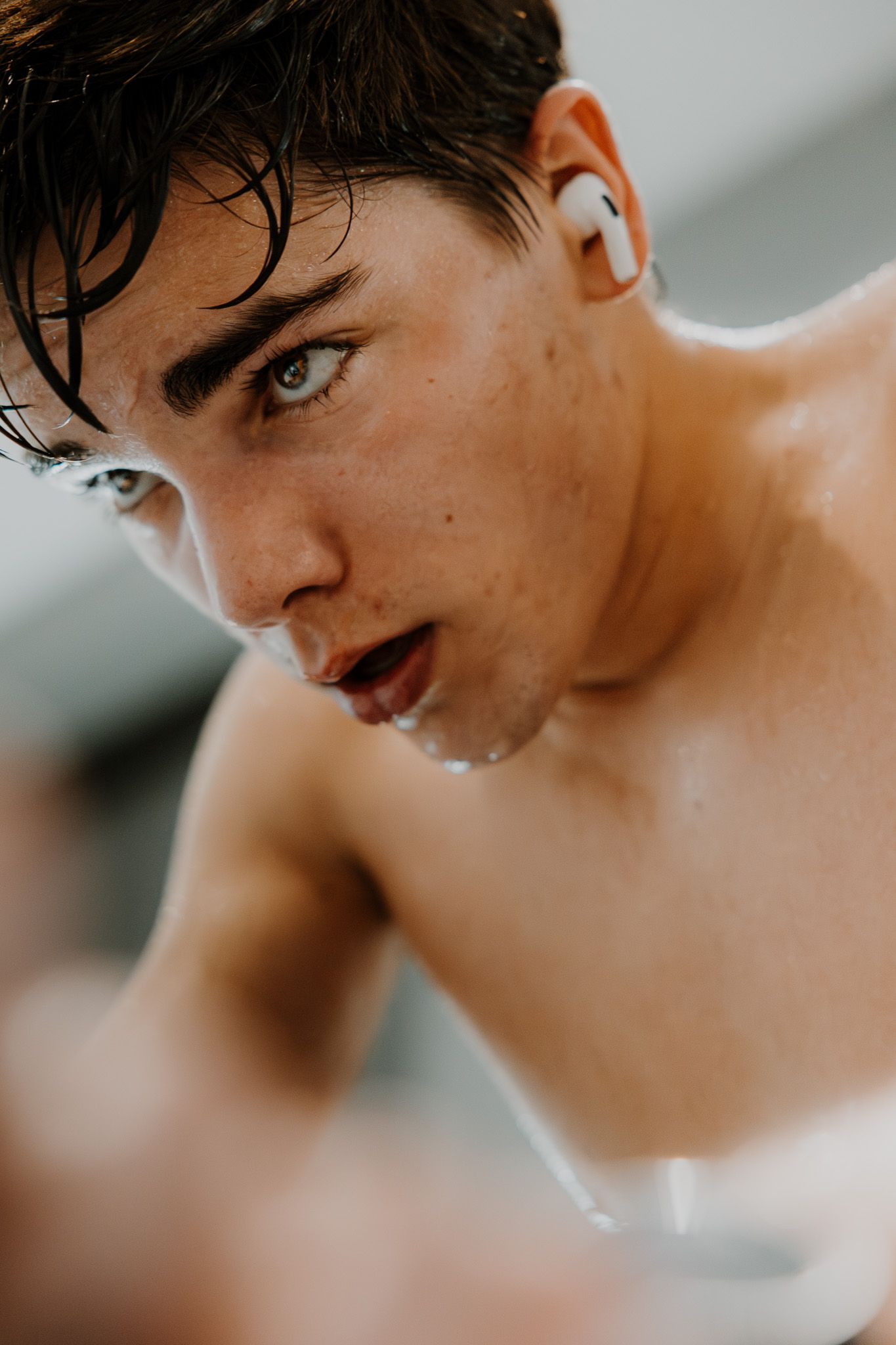 Close-up profile shots showing dark wet hair and intense expressions in dramatic lighting.