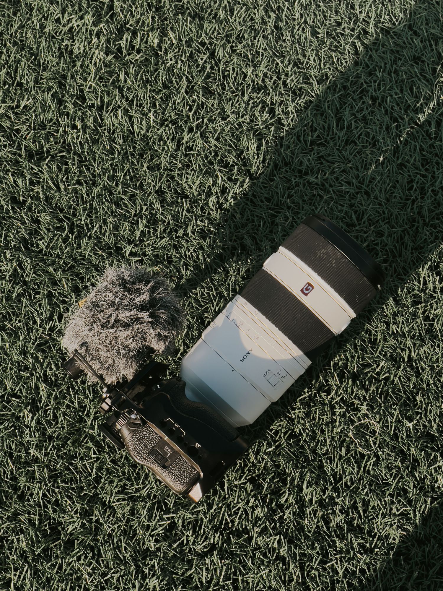 Sequence of iPhone smashing into grass lawn showing progressive damage and screen shattering in slow motion.