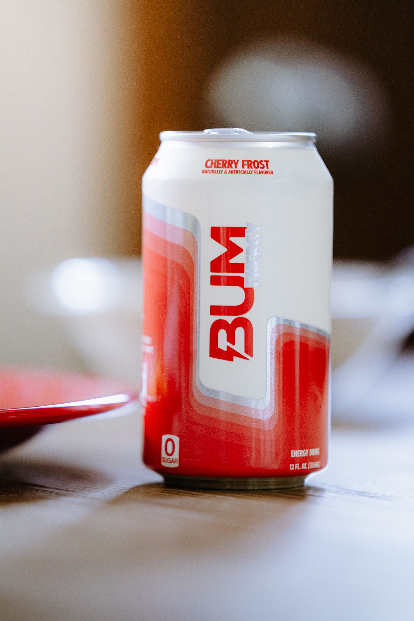 Multiple cans of Cherry Frost energy drink shown in a soft focus product photography sequence.