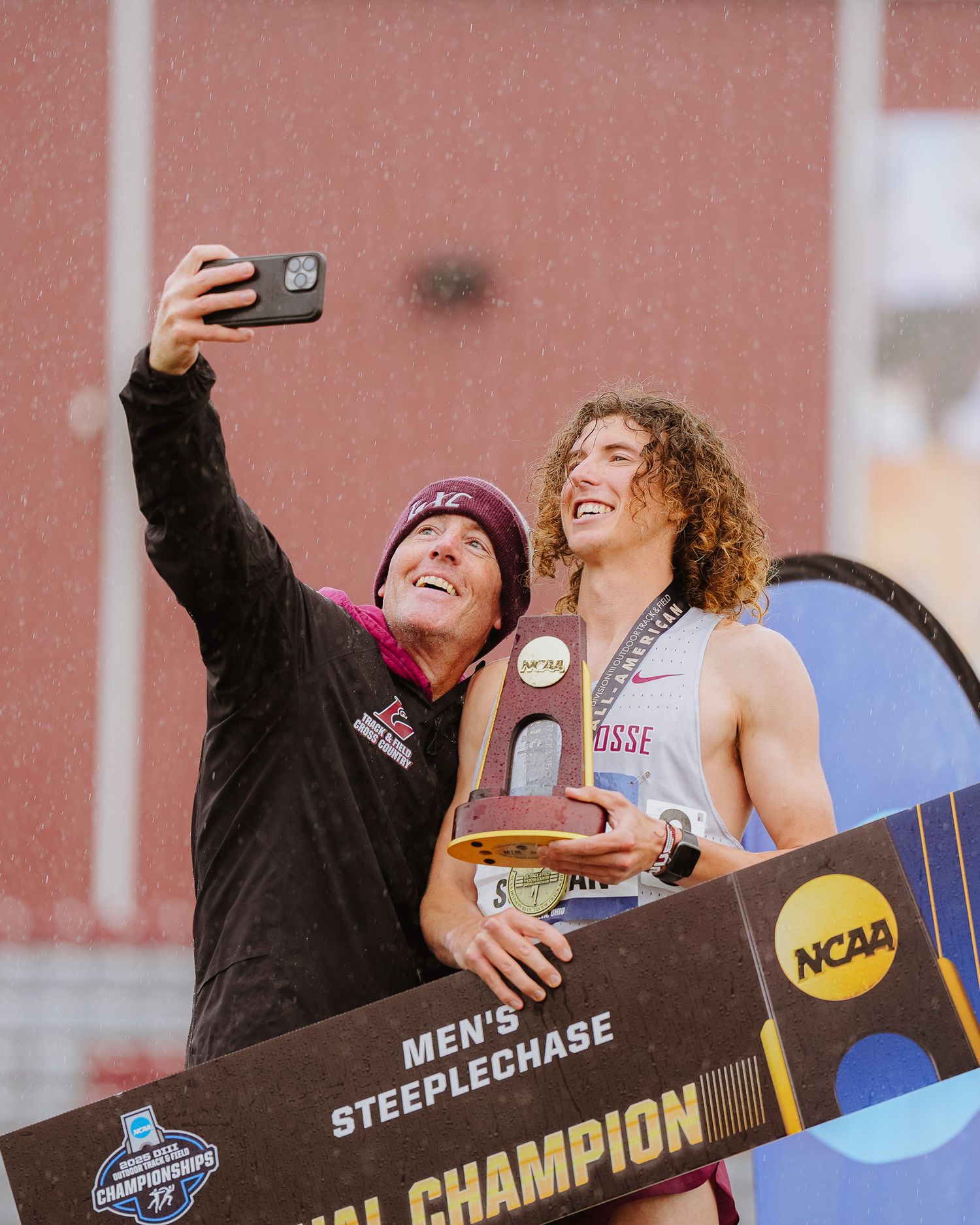 Athletes celebrating and taking selfies at an NCAA track and field championship event.