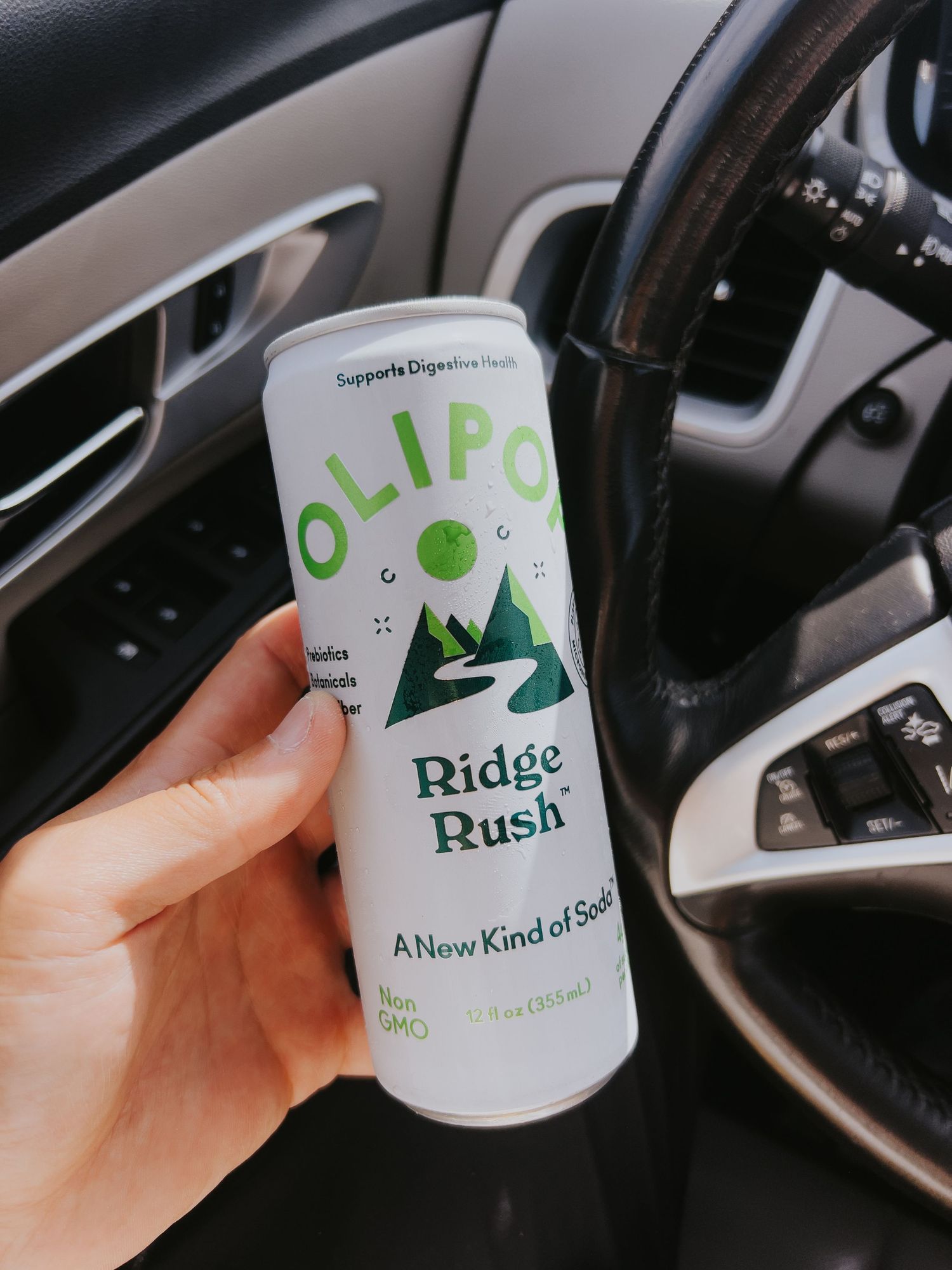 White disposable coffee cups with green Ridge Rush branding shown in a car interior setting.