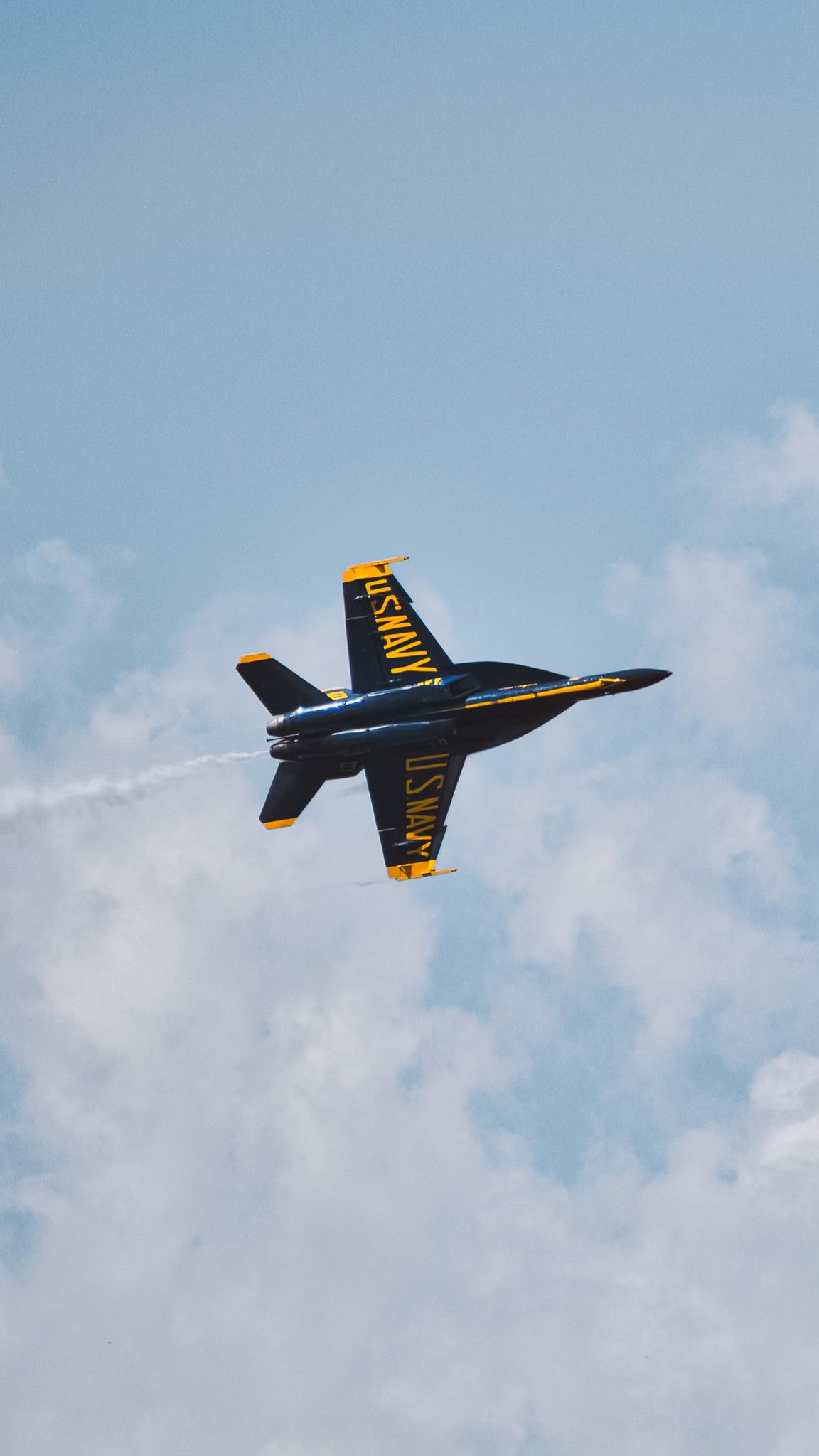 A sequence of a U.S. Navy Blue Angels aircraft performing aerial maneuvers against a blue sky.