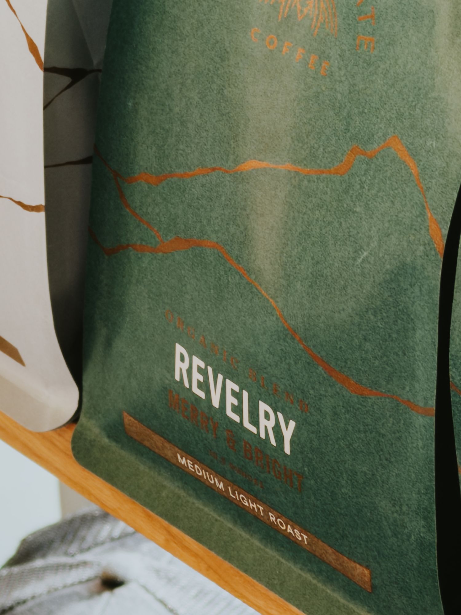 A green book cover with orange line art illustrations and text displayed from multiple angles.