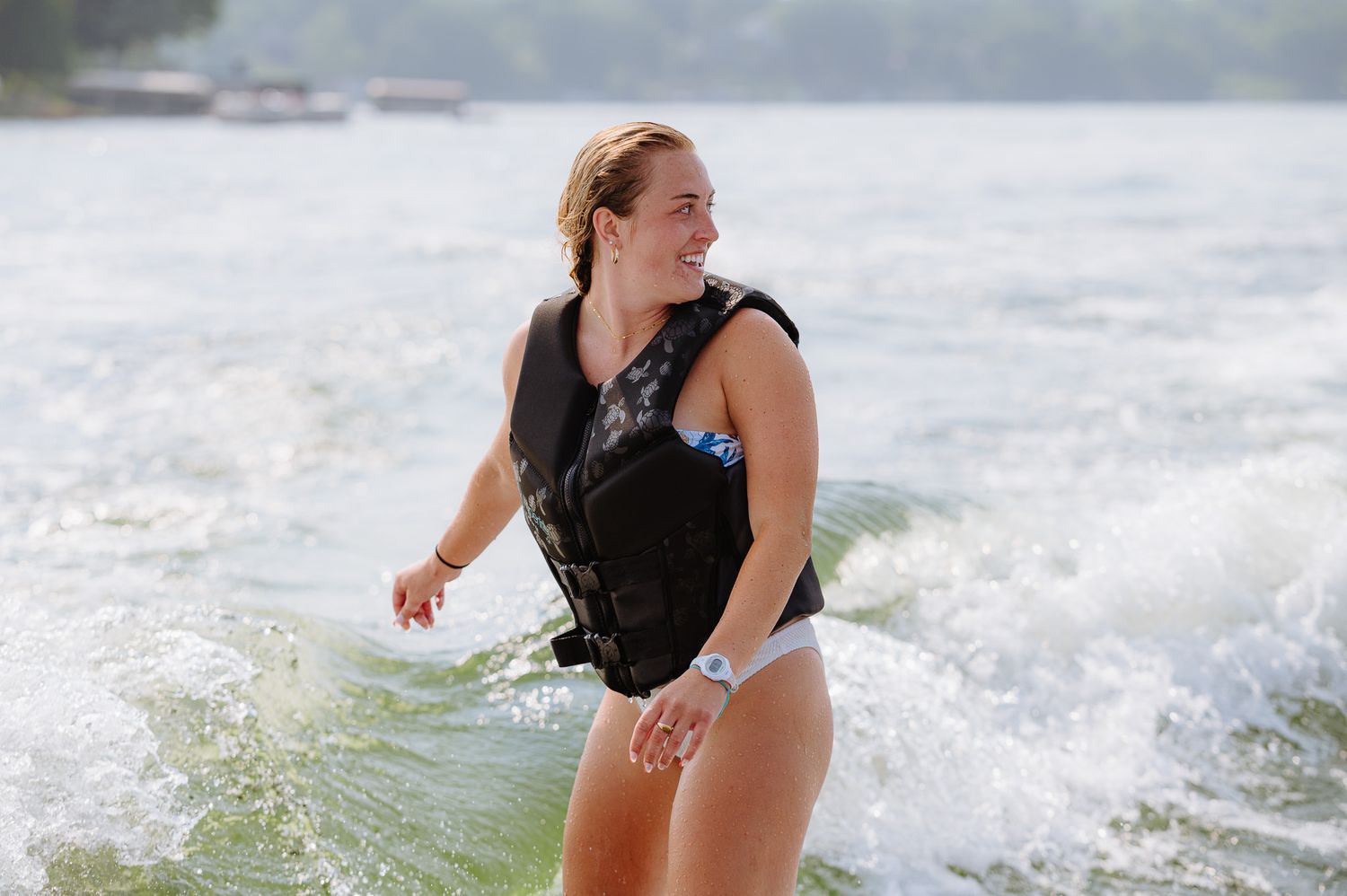 Action shot of wakeboarding on a lake with water spray.