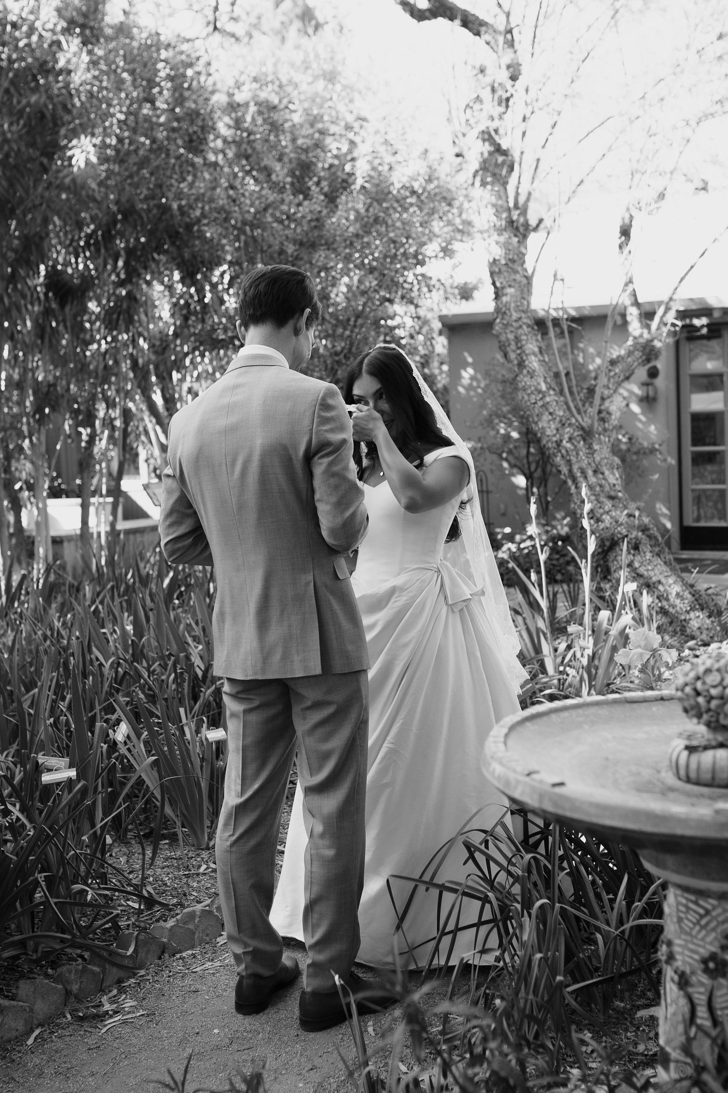 Candid and emotional first look between the bride and groom, captured on film-inspired tones.Intimate embrace between couple
Authentic love
