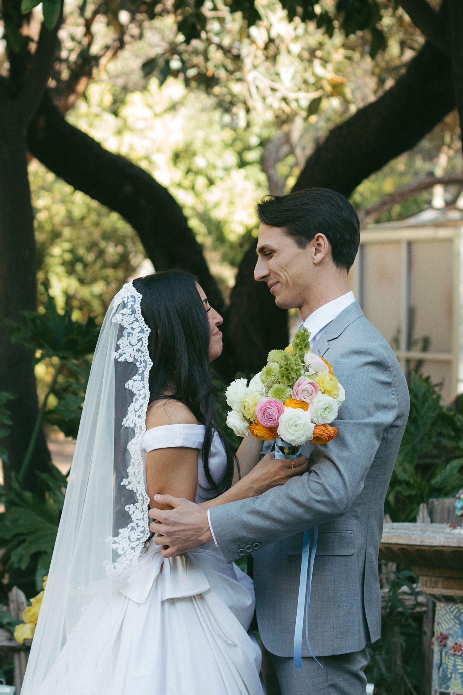 Candid and emotional first look between the bride and groom, captured on film-inspired tones.