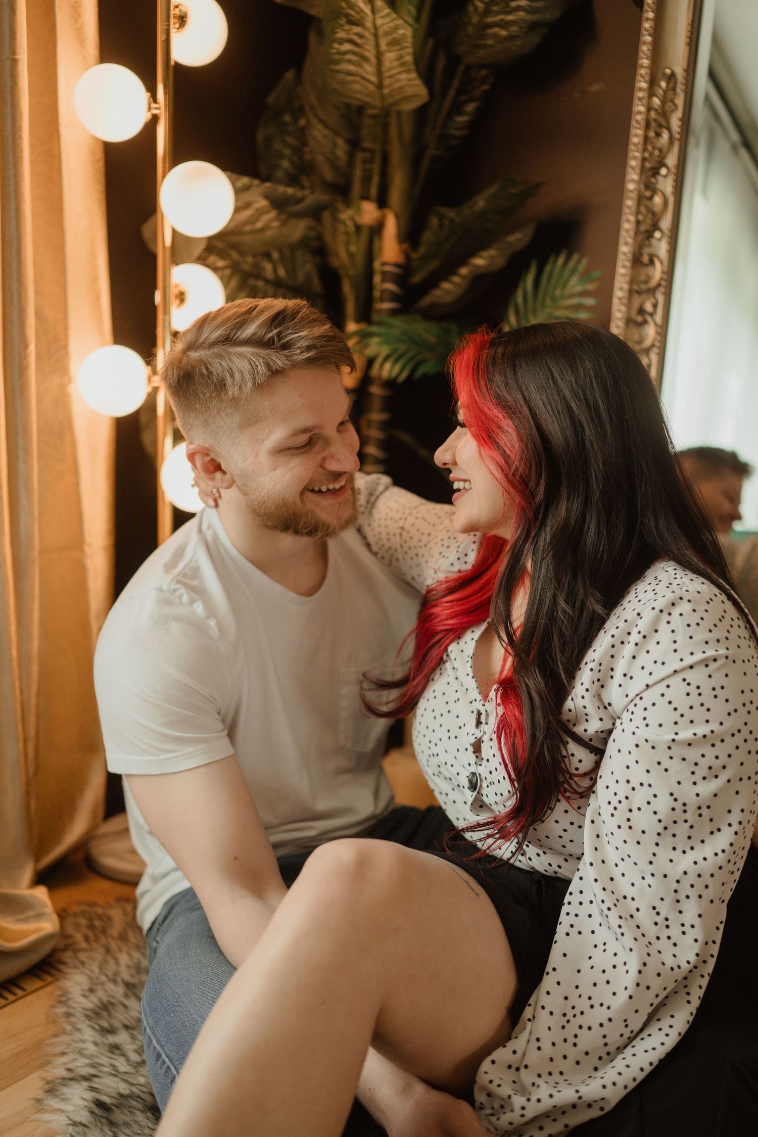 A romantic moment captured in warm lighting with a couple sitting close together.