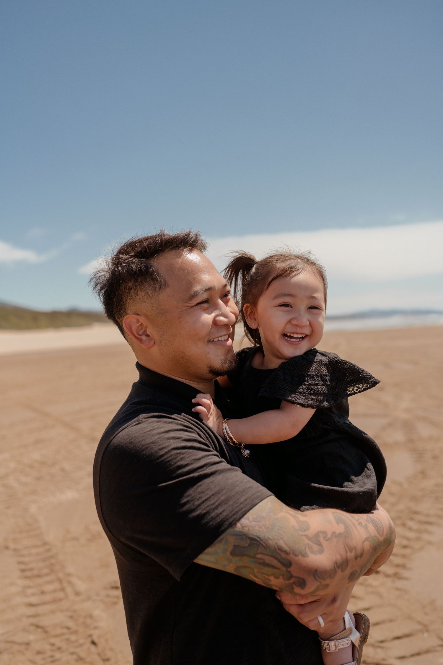 A sweet moment between parent and child on a sunny beach.