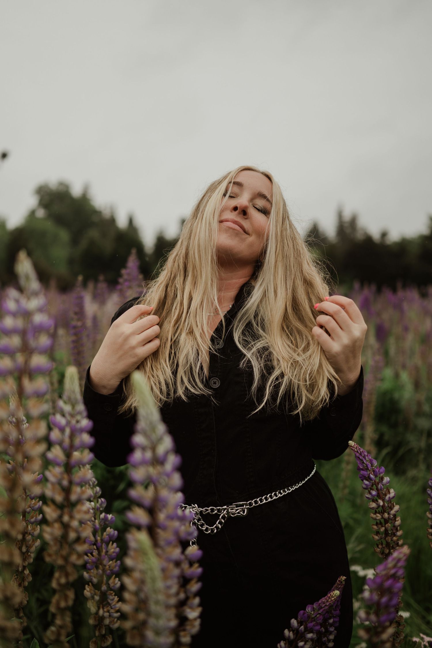 A dreamy portrait in a field of purple lupines during golden hour.