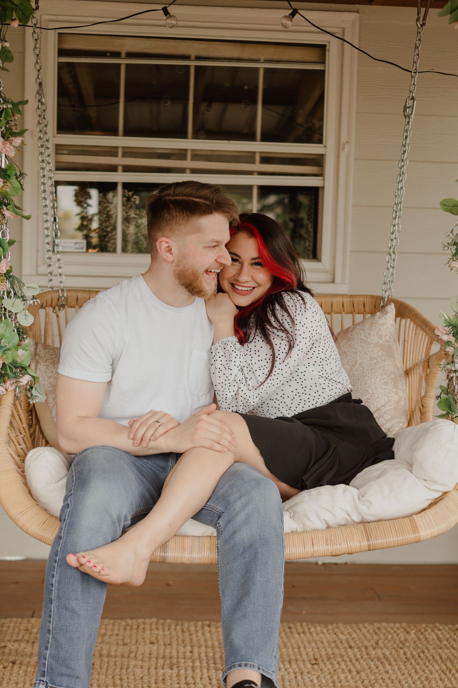 Couple sharing intimate moment on cozy porch swing.