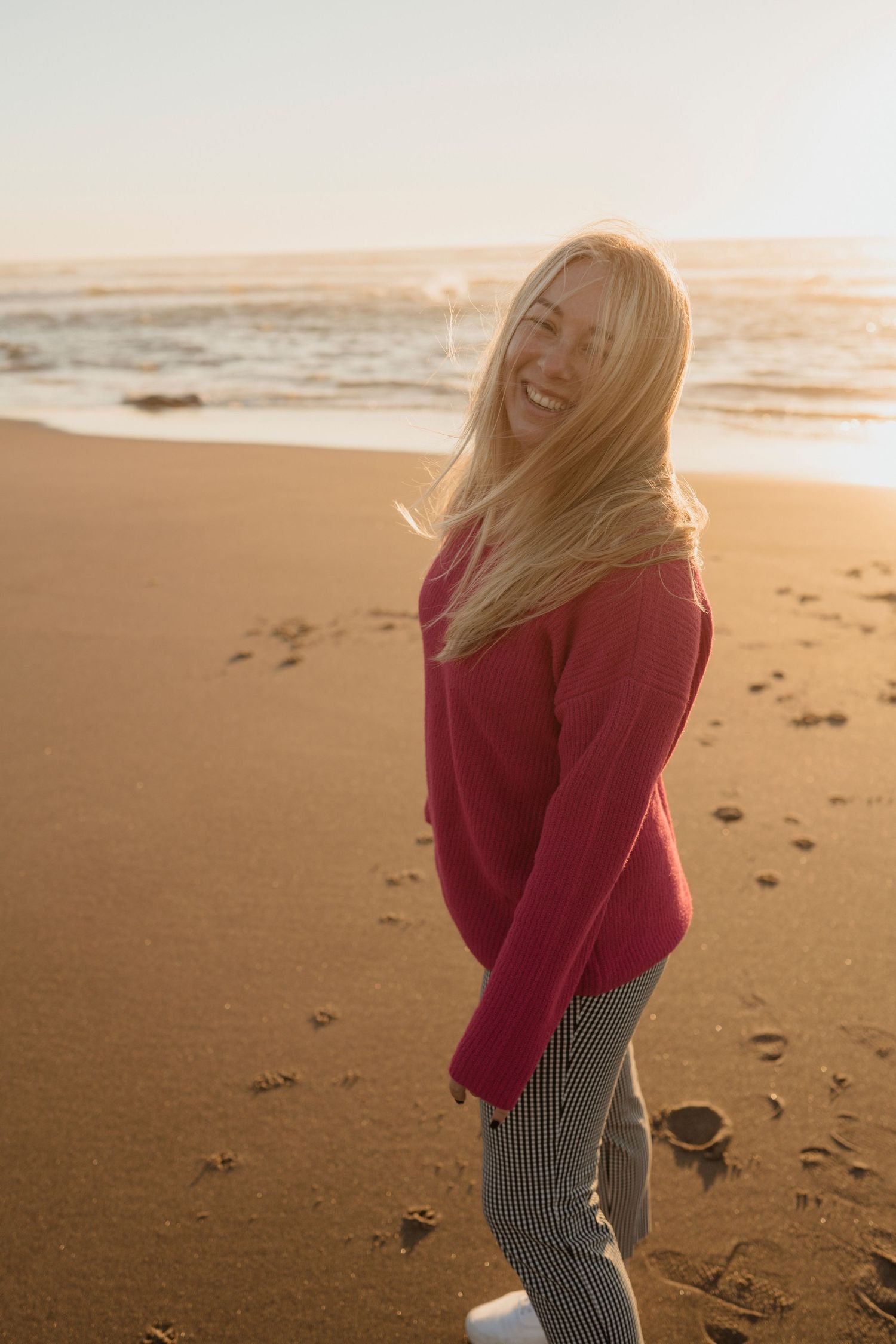 A joyful moment captured at sunset on a sandy beach.