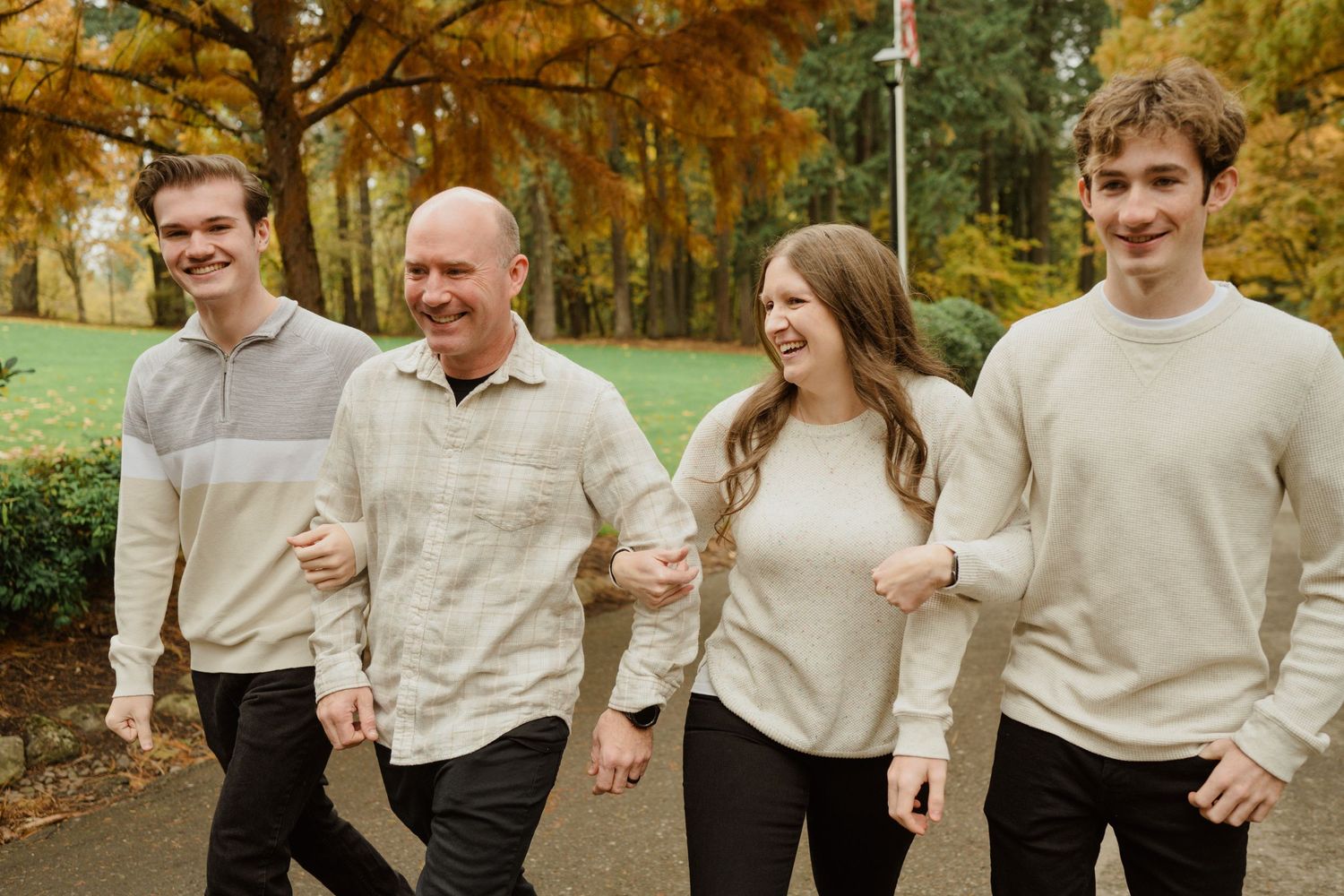 Group walking together in coordinated cream-colored sweaters during fall season.