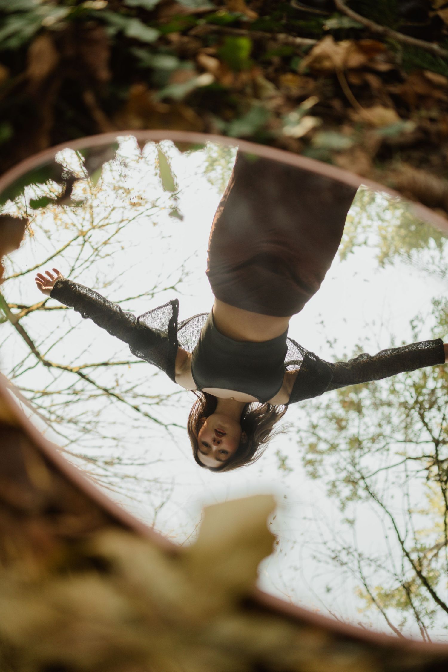 Artistic overhead mirror reflection shot in woodland setting with natural light.