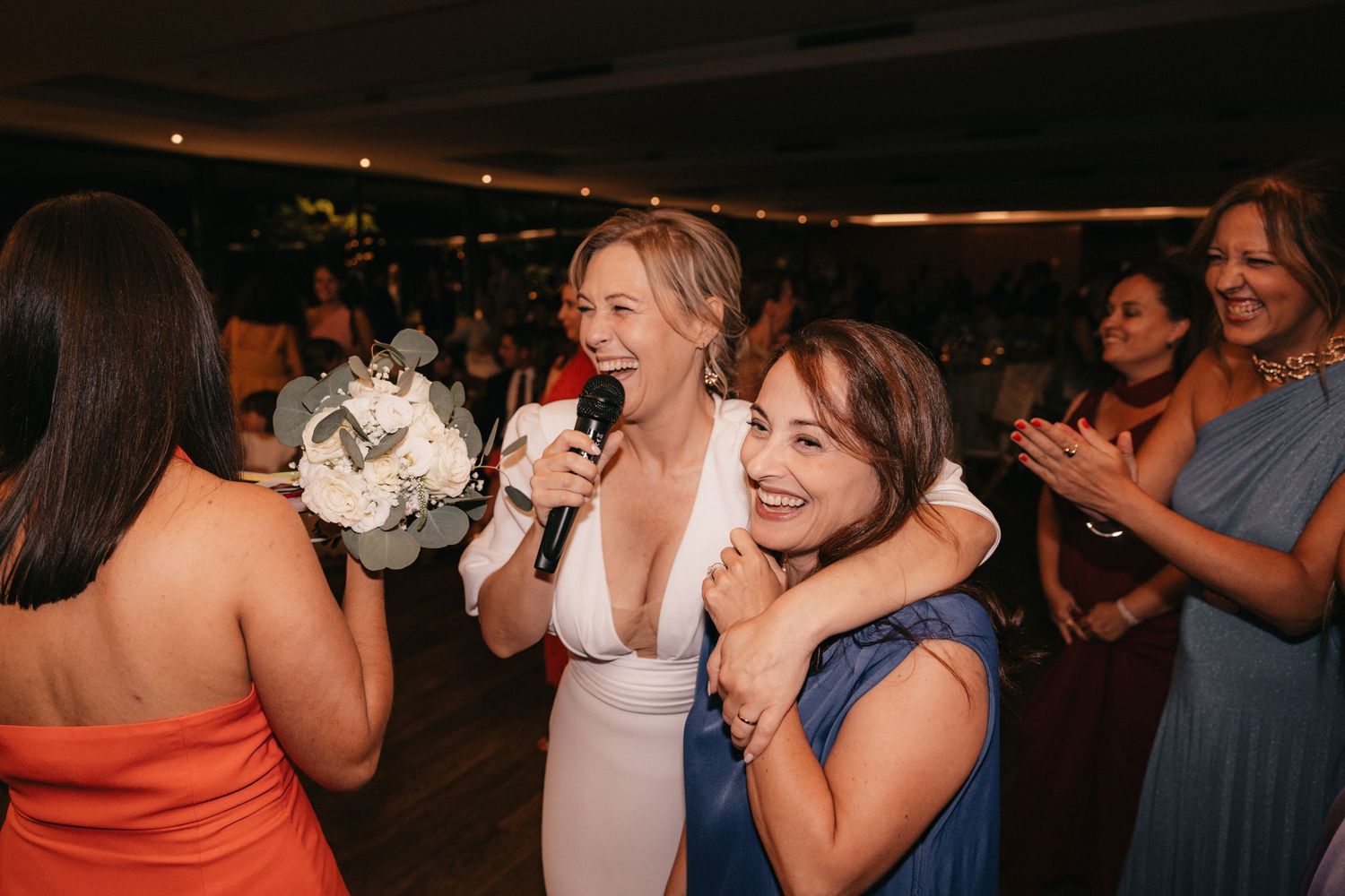 Wedding celebration with guests in formal attire dancing and celebrating.