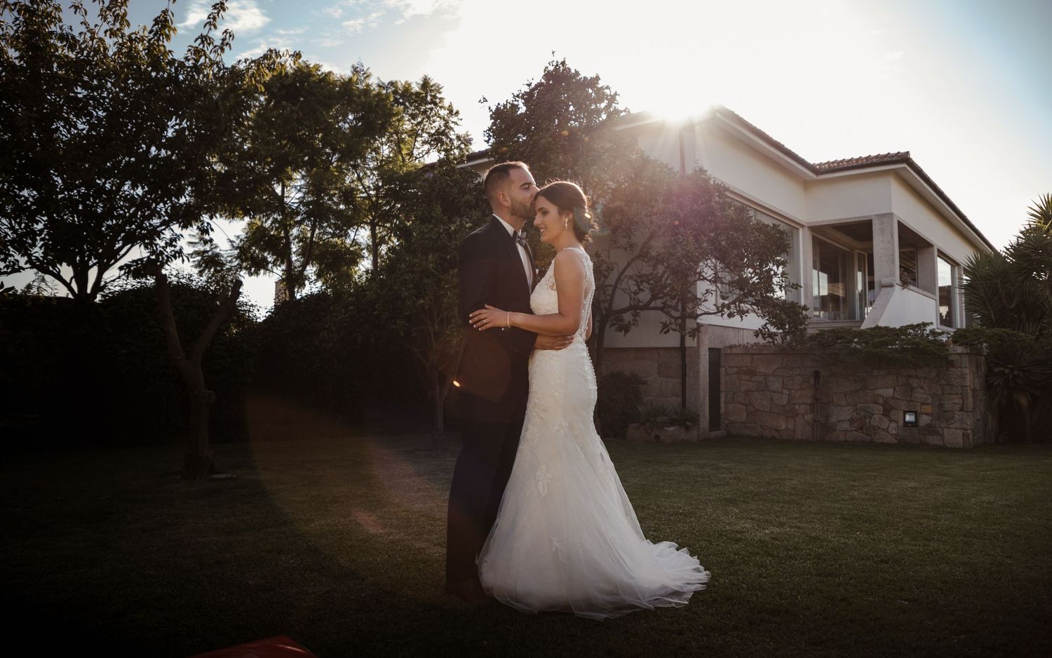 A dreamy sunset wedding portrait captures a couple embracing on their special day.