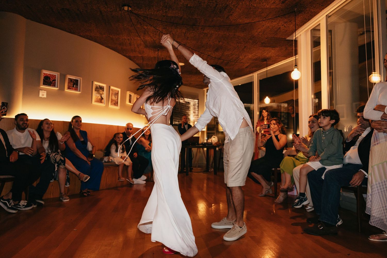 Energetic dance performance at wedding reception with guests watching from the sides.
