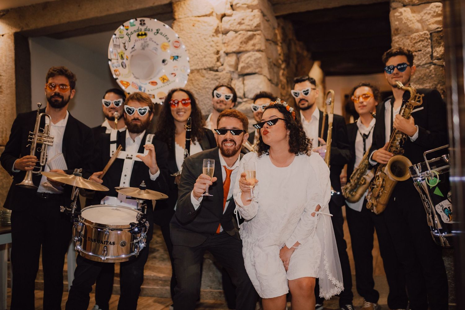 A live band in formal attire performs at an indoor venue with various instruments.