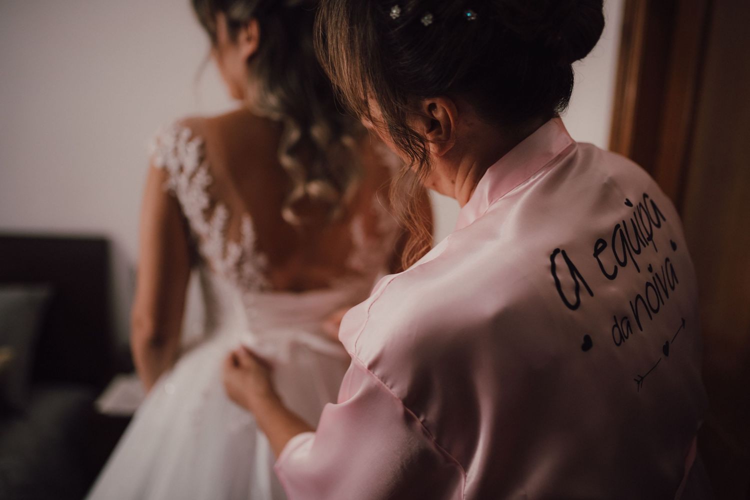 Detail shot of embroidered text on pink wedding day attire.