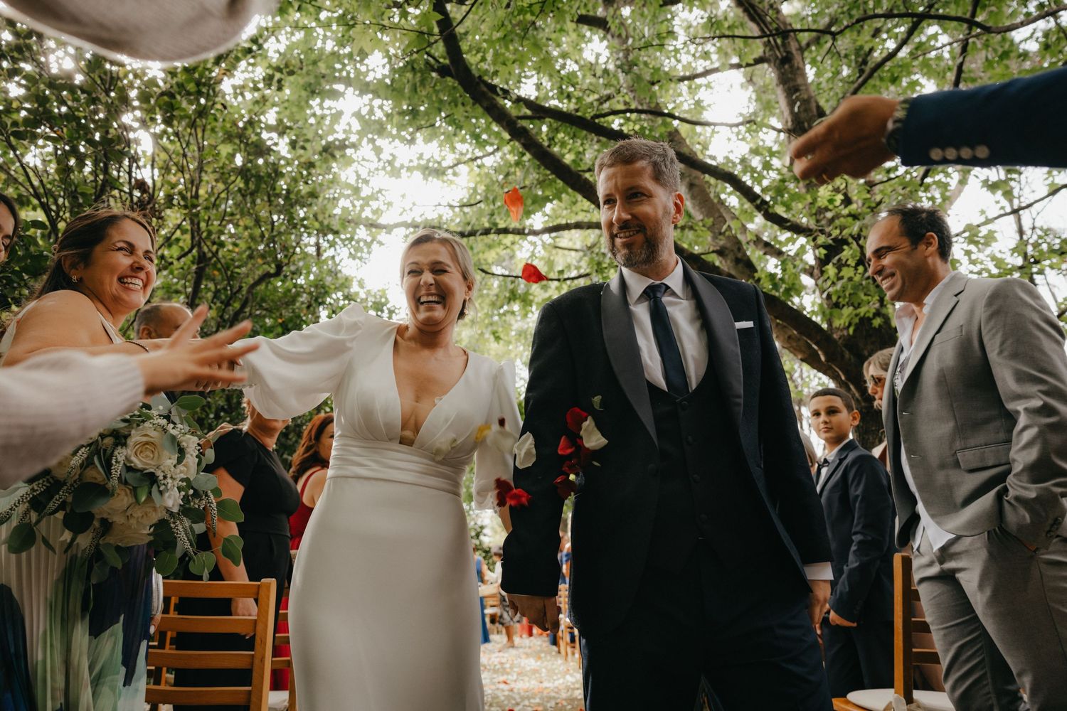 Guests celebrate with champagne at an outdoor wedding celebration.