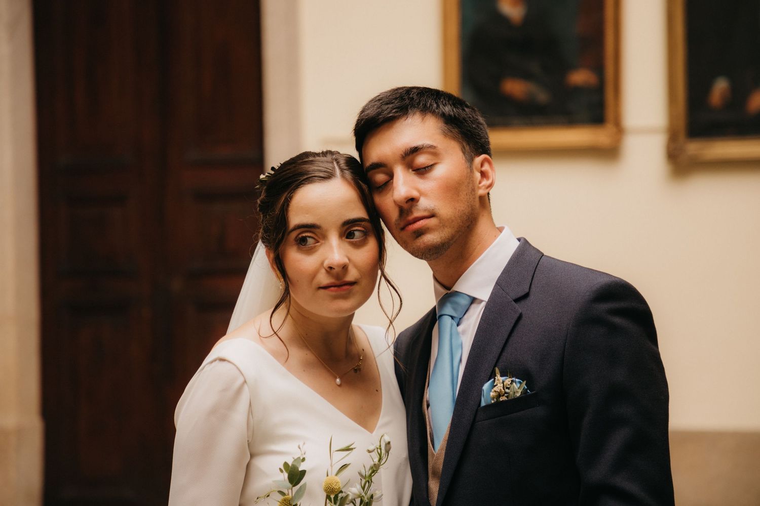 Elegant wedding portrait in a formal indoor setting with classic decor.