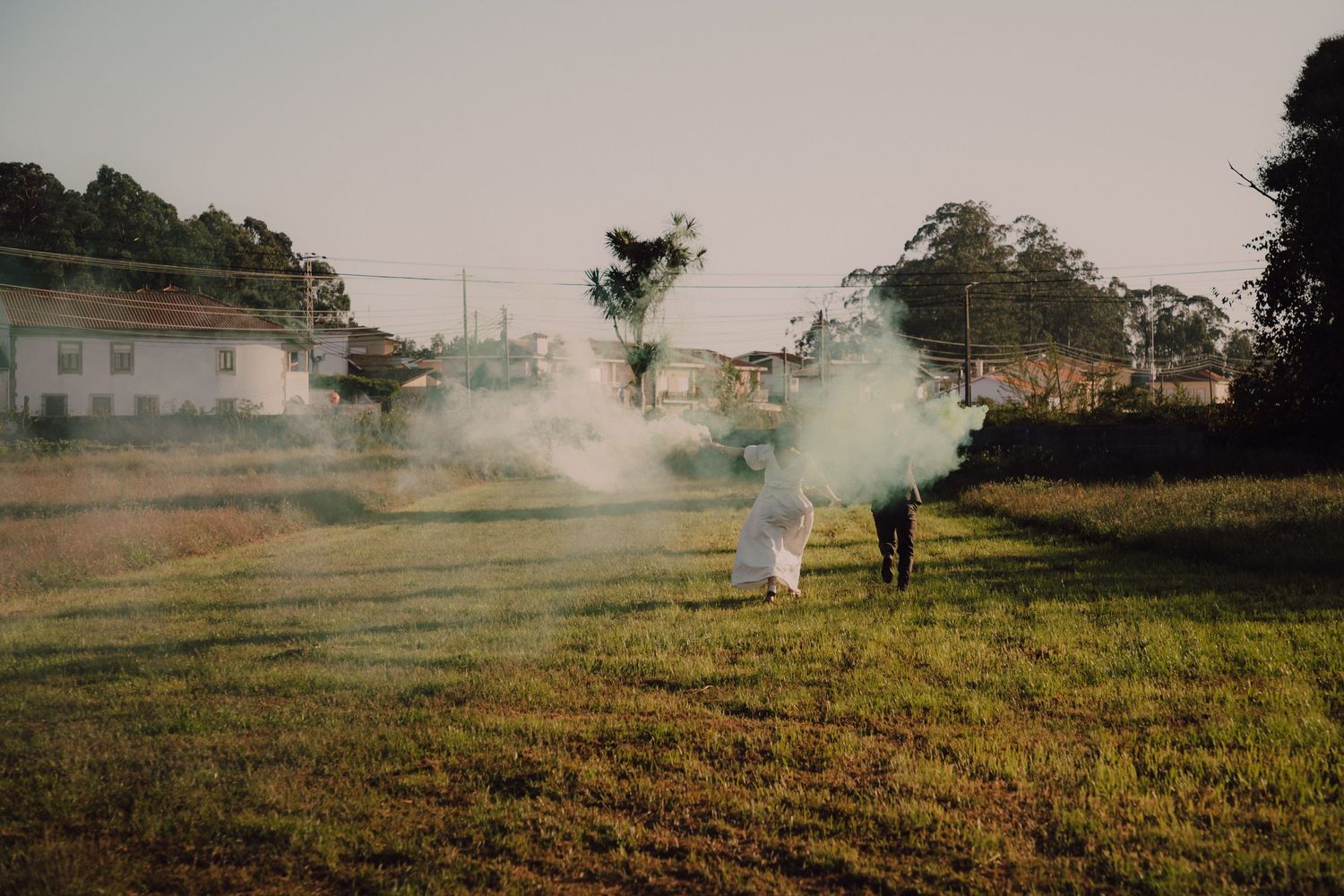 Figure walks through misty field at dusk creating atmospheric smoke effects.