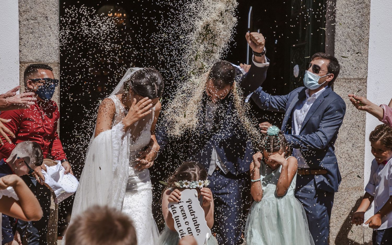 Celebratory moment at a wedding ceremony as guests shower the newlyweds with confetti on their special day.