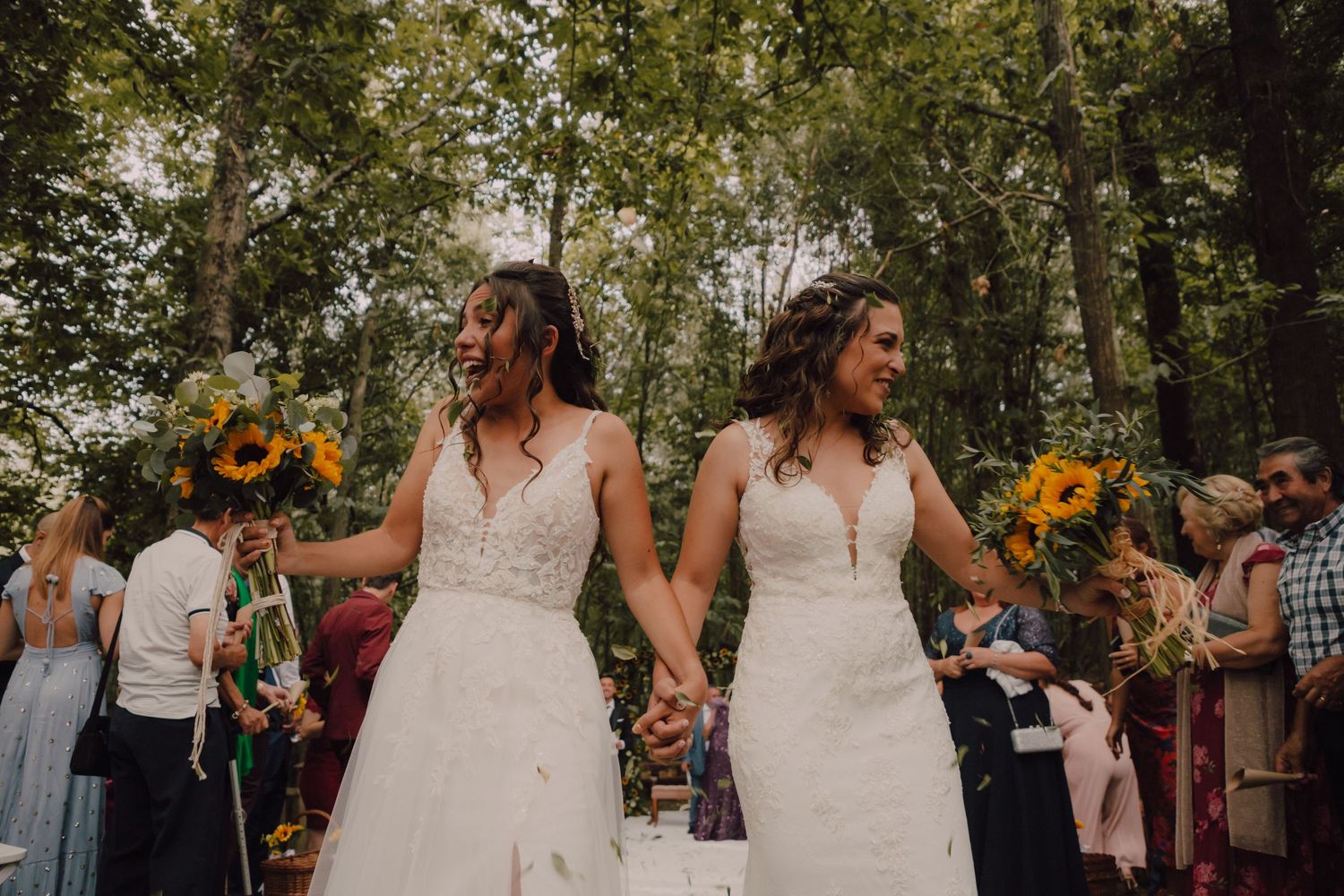 Wedding celebration in forest setting with sunflowers and natural decor.