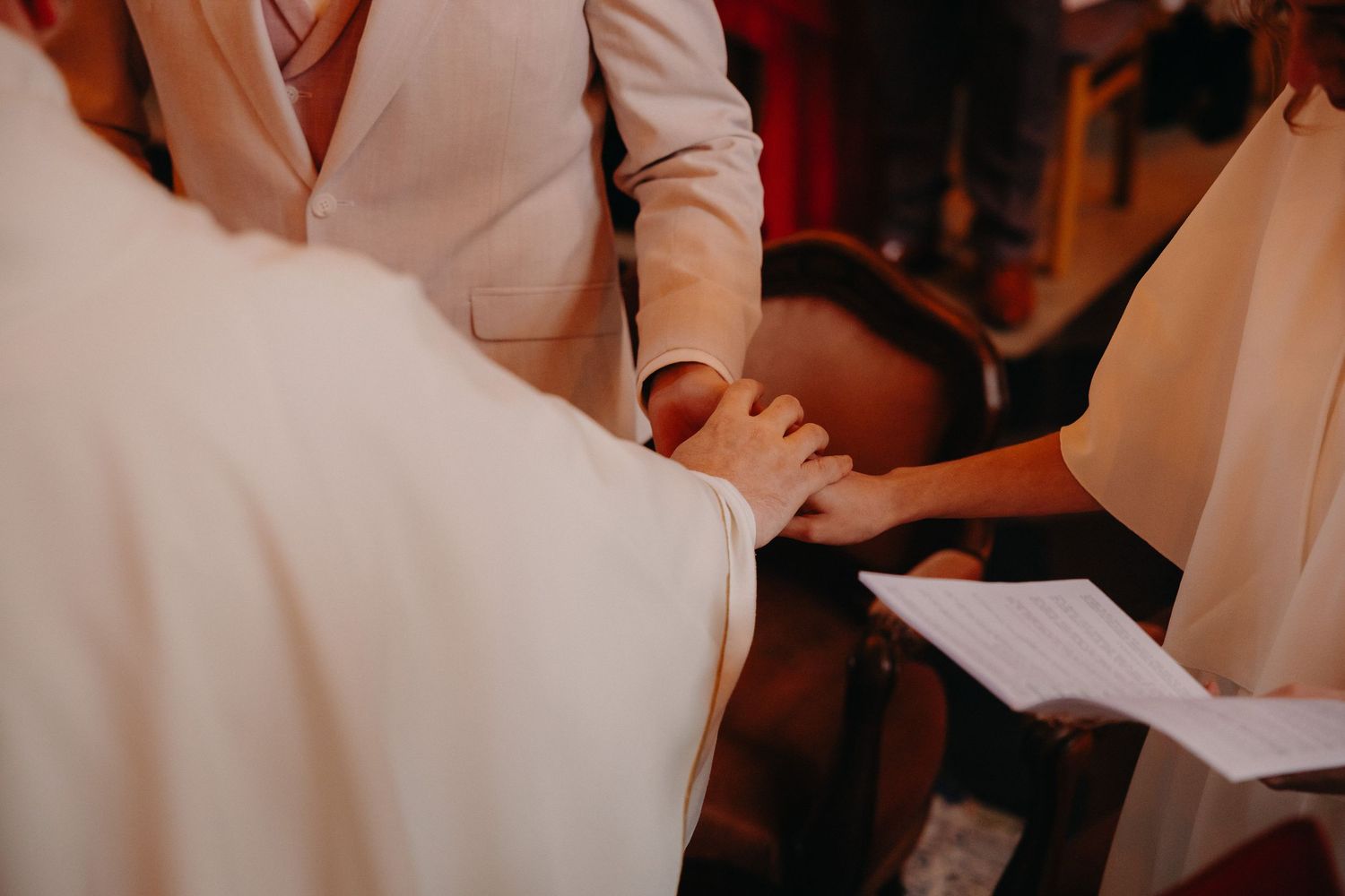 A couple in formal wedding attire shares a romantic dance together during their wedding reception.