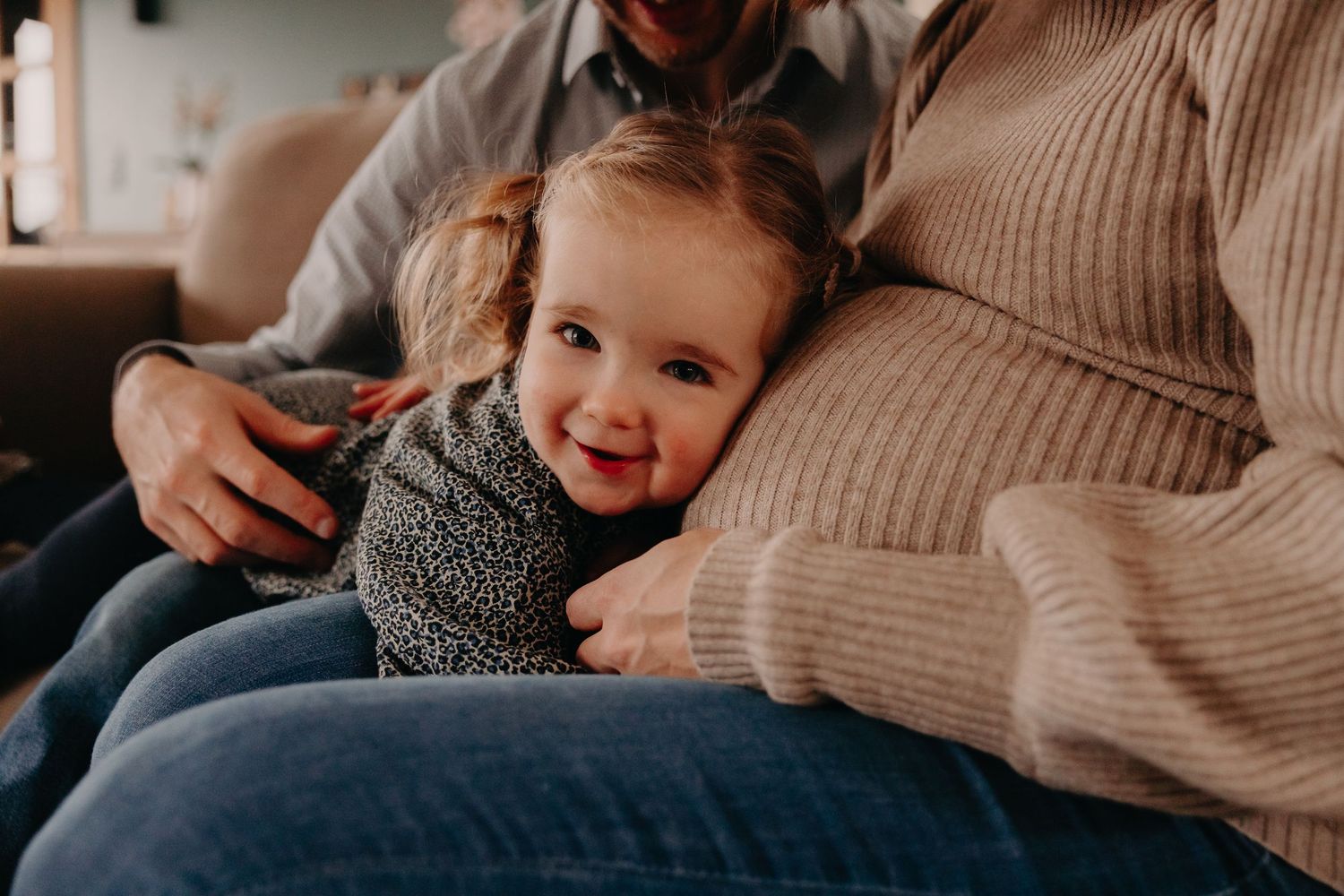 A series of candid family moments showing tender interactions between parent and child in cozy sweaters.