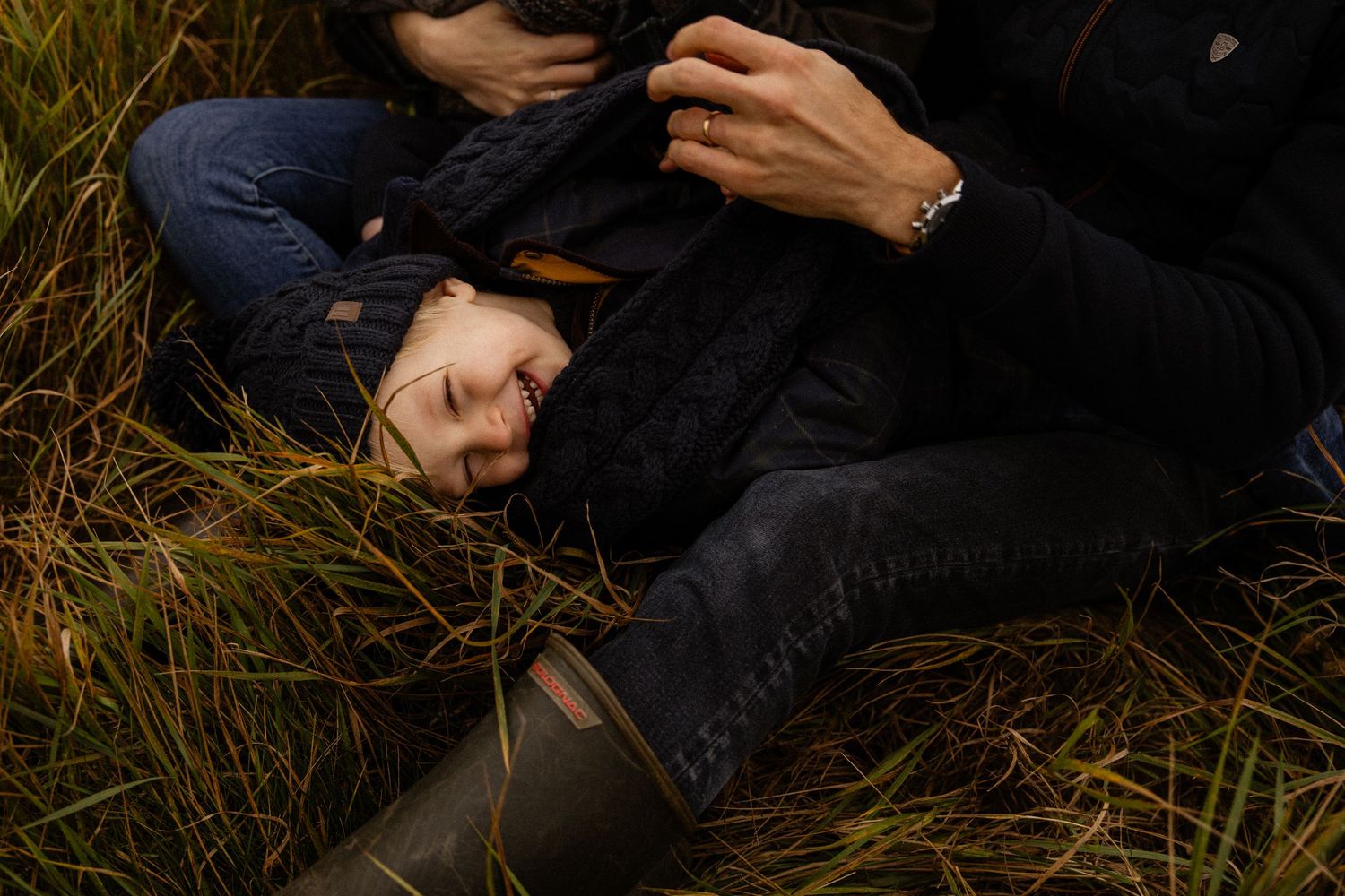 A series of cropped artistic photographs showing hands and body parts against dark and natural backgrounds.