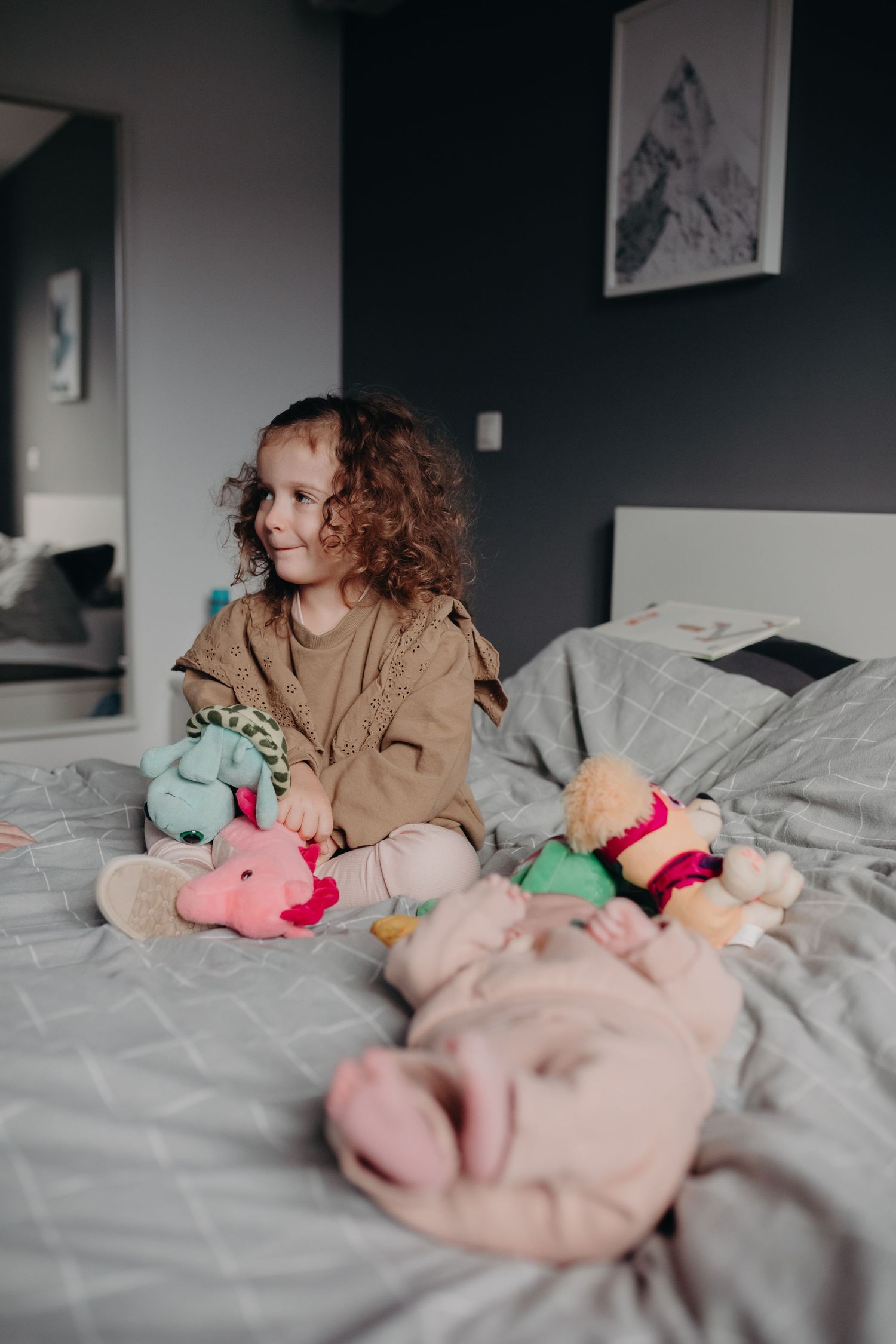 A series of four photos showing a collection of plush toys arranged on gray bedding.