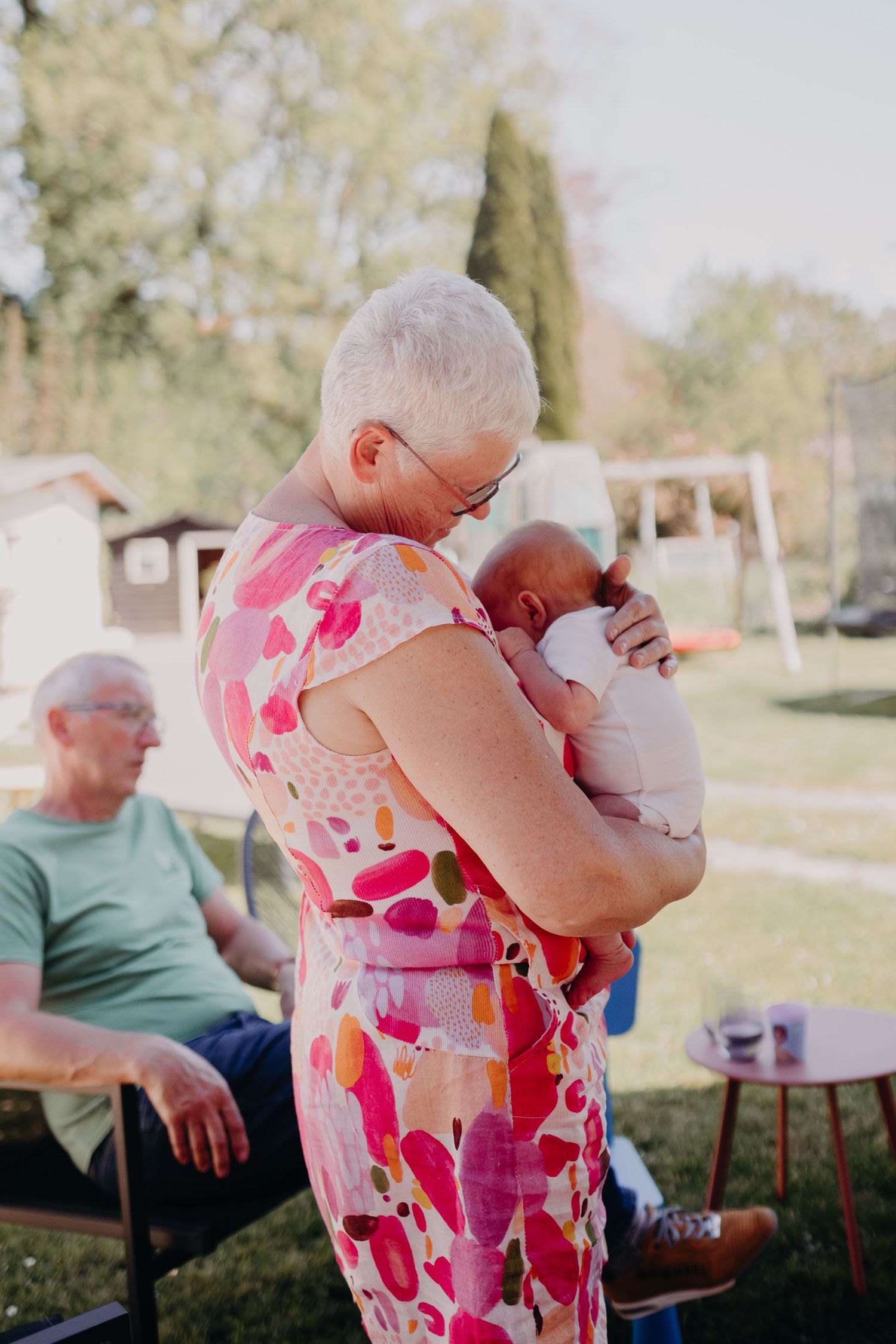 A series of candid outdoor moments showing family bonding and affection on a sunny day.