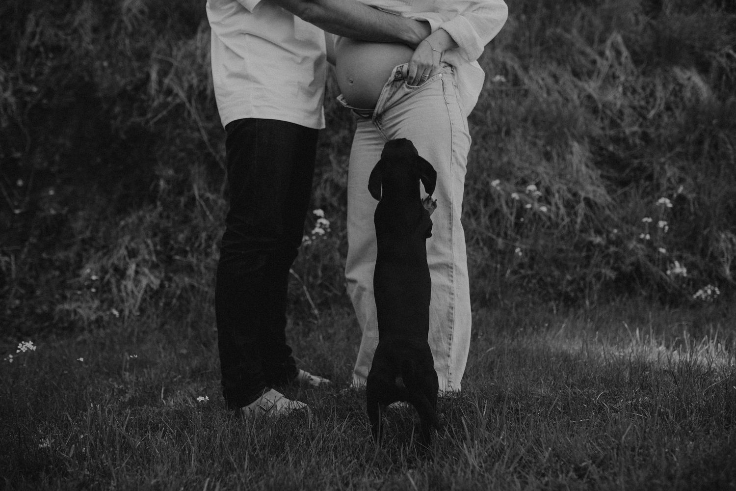 A black and white collage of candid moments between two people walking and embracing outdoors.