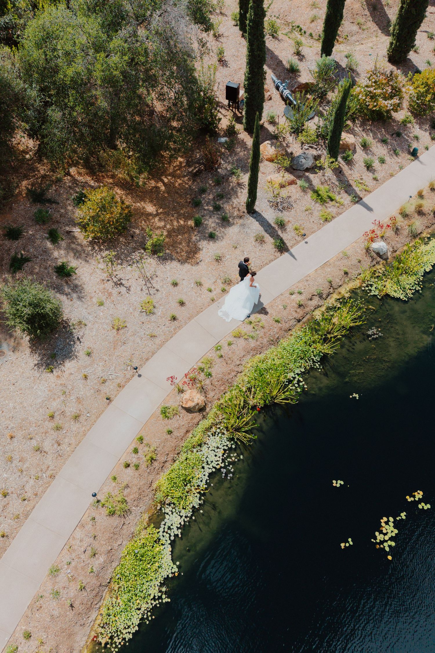 Couple walking a coastal cliffside path overlooking the water during a seaside elopement.