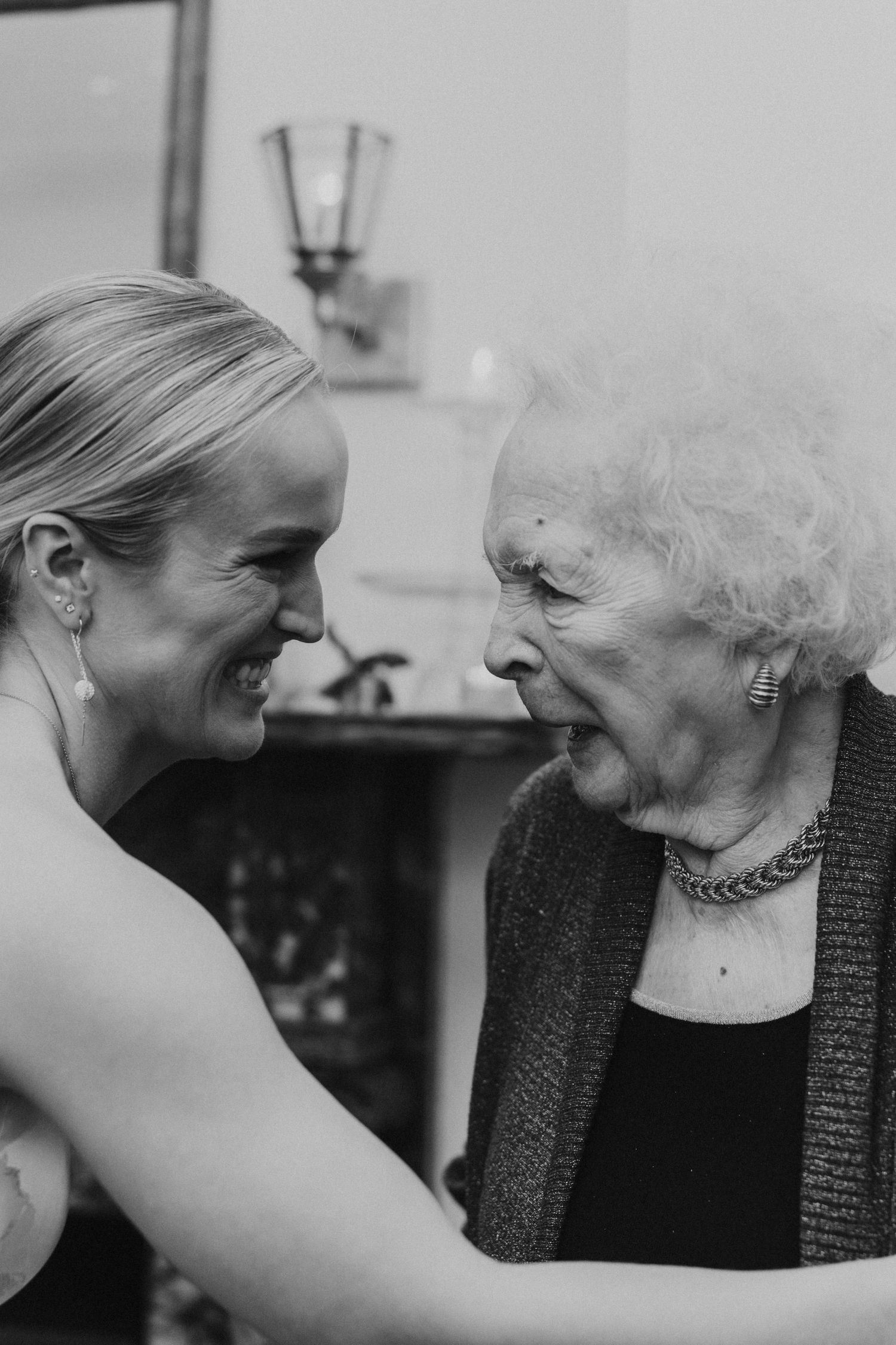 Intimate black and white moment between a bride and her grandmother captured on the wedding day.