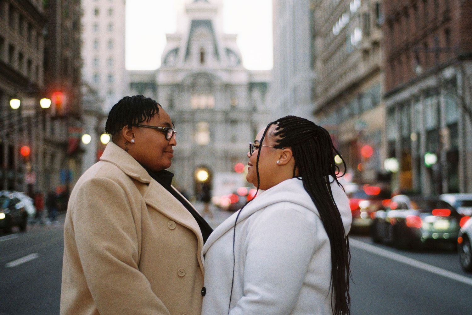 Couple facing each other on a city street during an urban engagement session.