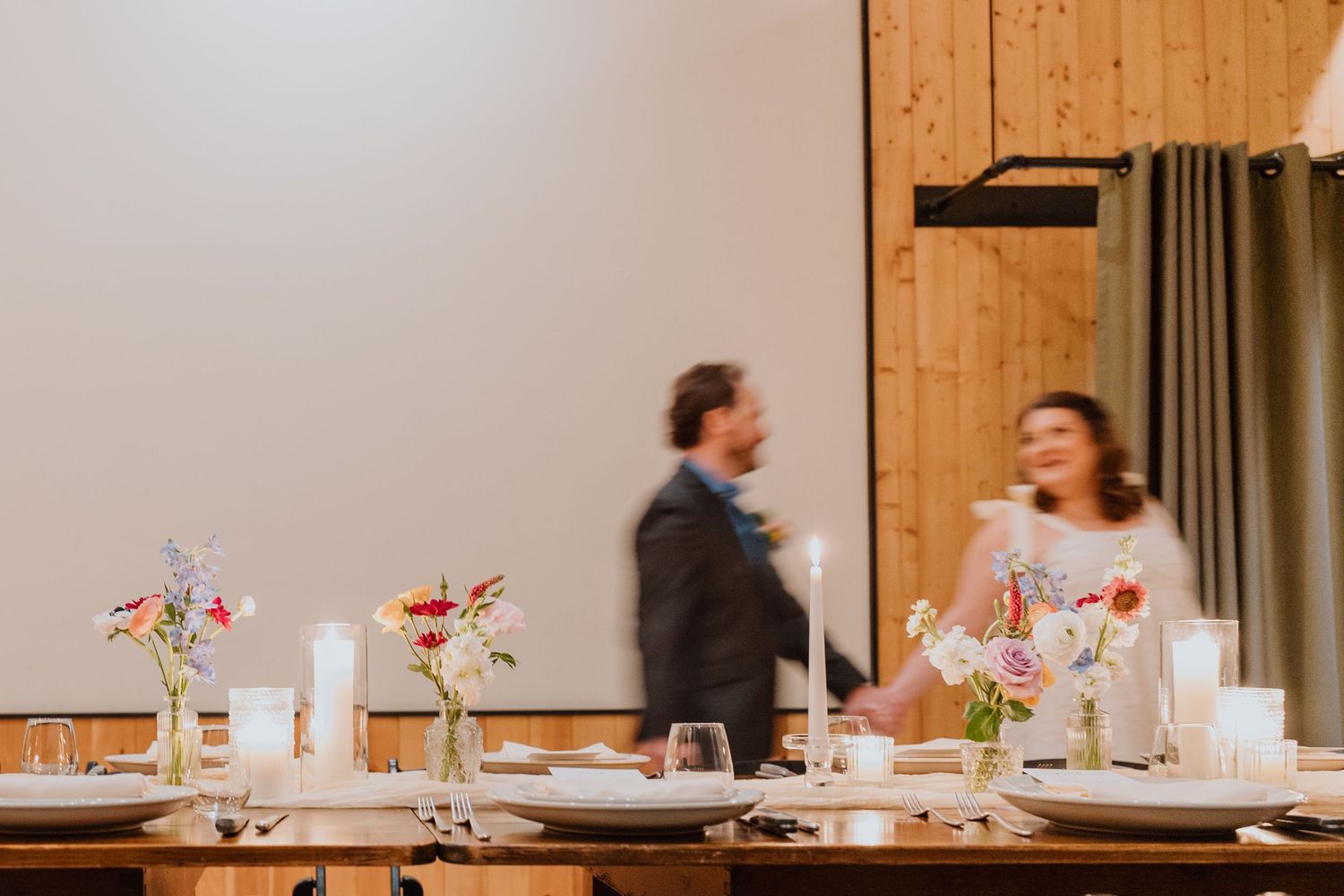 Couple seated at their sweetheart table during the reception.