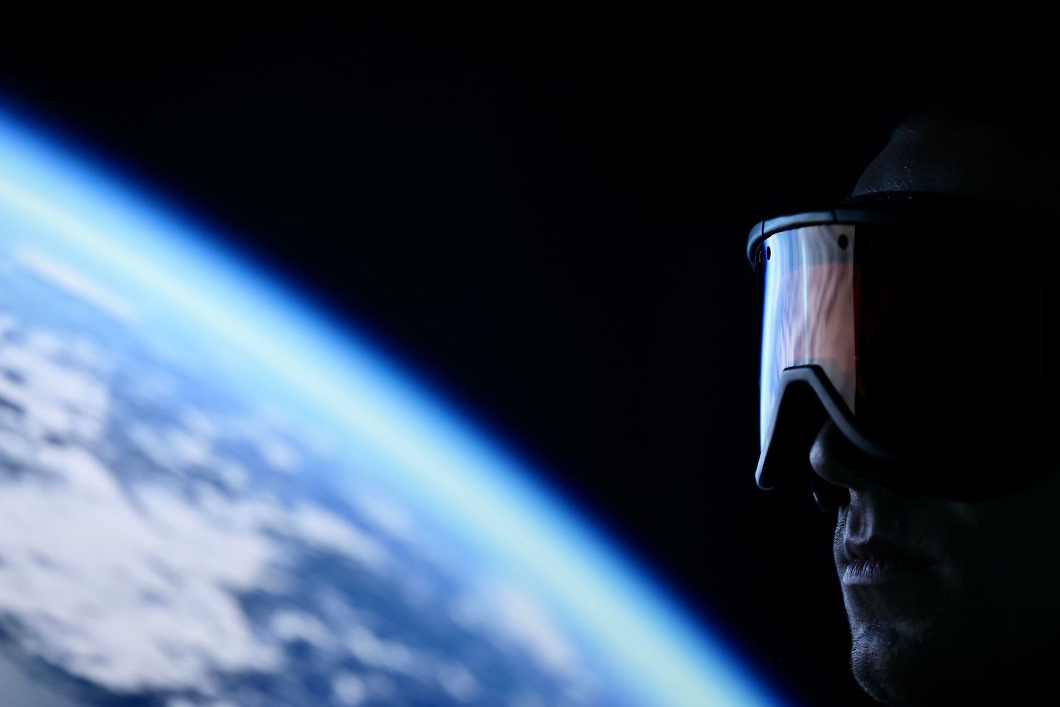 Cinematic portrait of man silhouetted against glowing Earth backdrop
