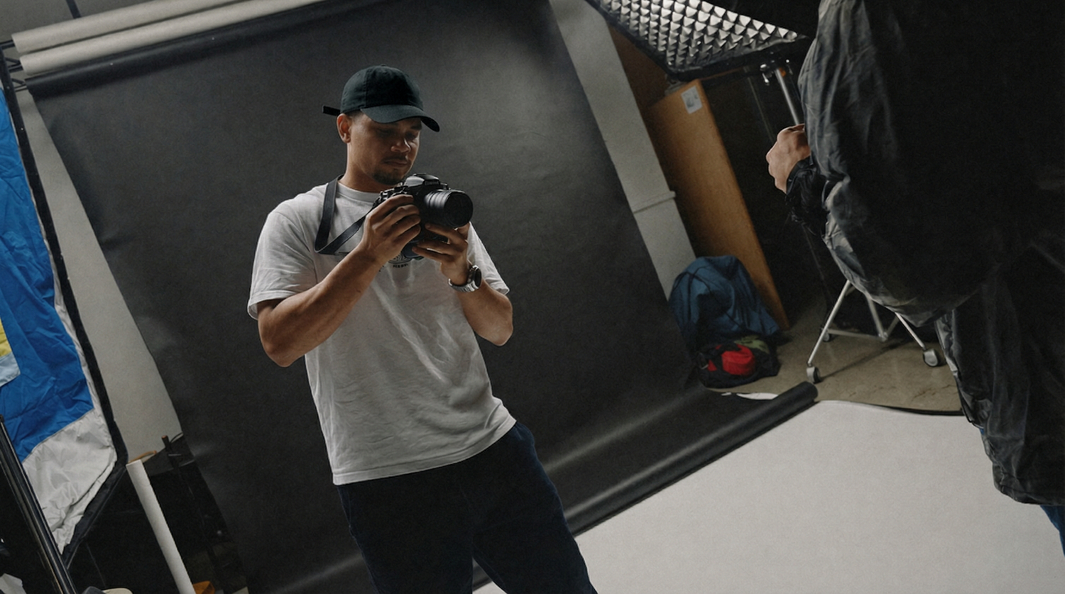 Photographer working in professional photography studio rental with backdrop and lighting setup