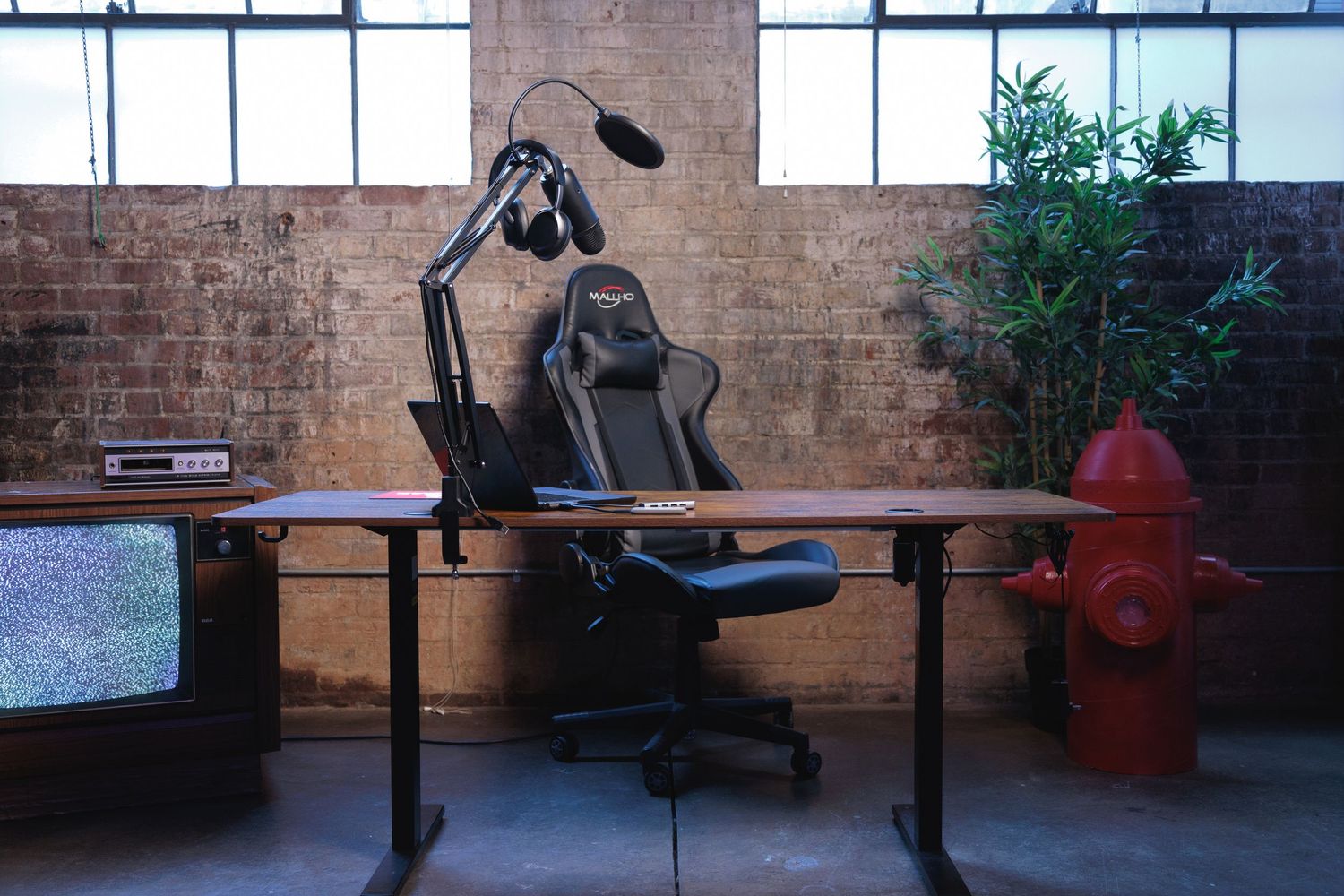 Creative studio space with desk and podcast setup for content creation, interviews, and video production