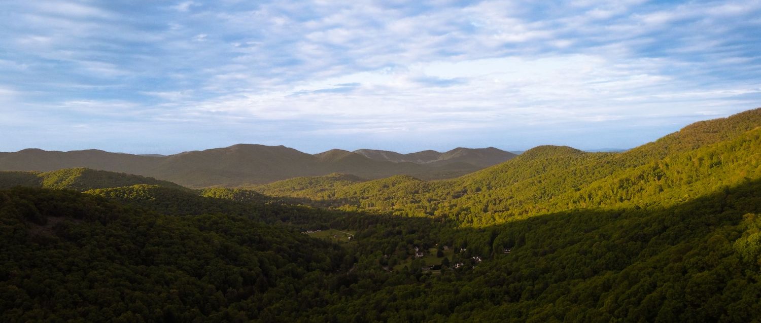Cinematic drone aerial of Asheville mountains capturing scale, light, and atmosphere