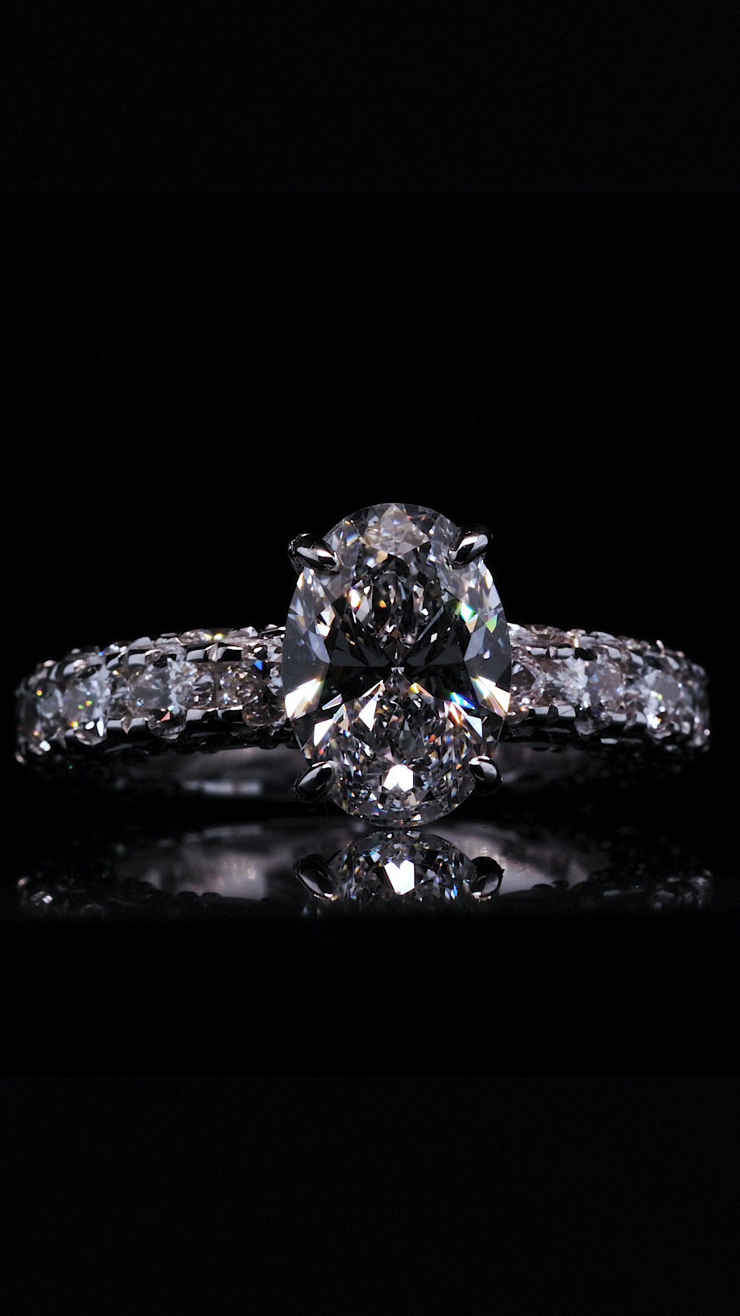 Luxury diamond engagement ring product photography on black reflective surface
