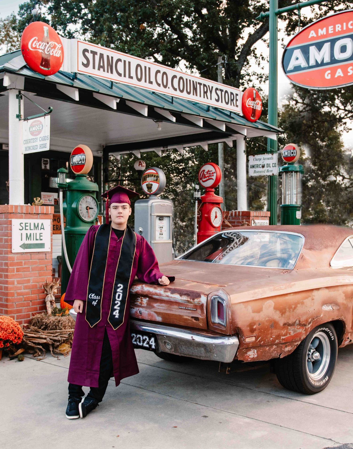 High school graduate posing with classic car in front of vintage gas station in Smithfield, NC taken by Krystie Nicole Photo