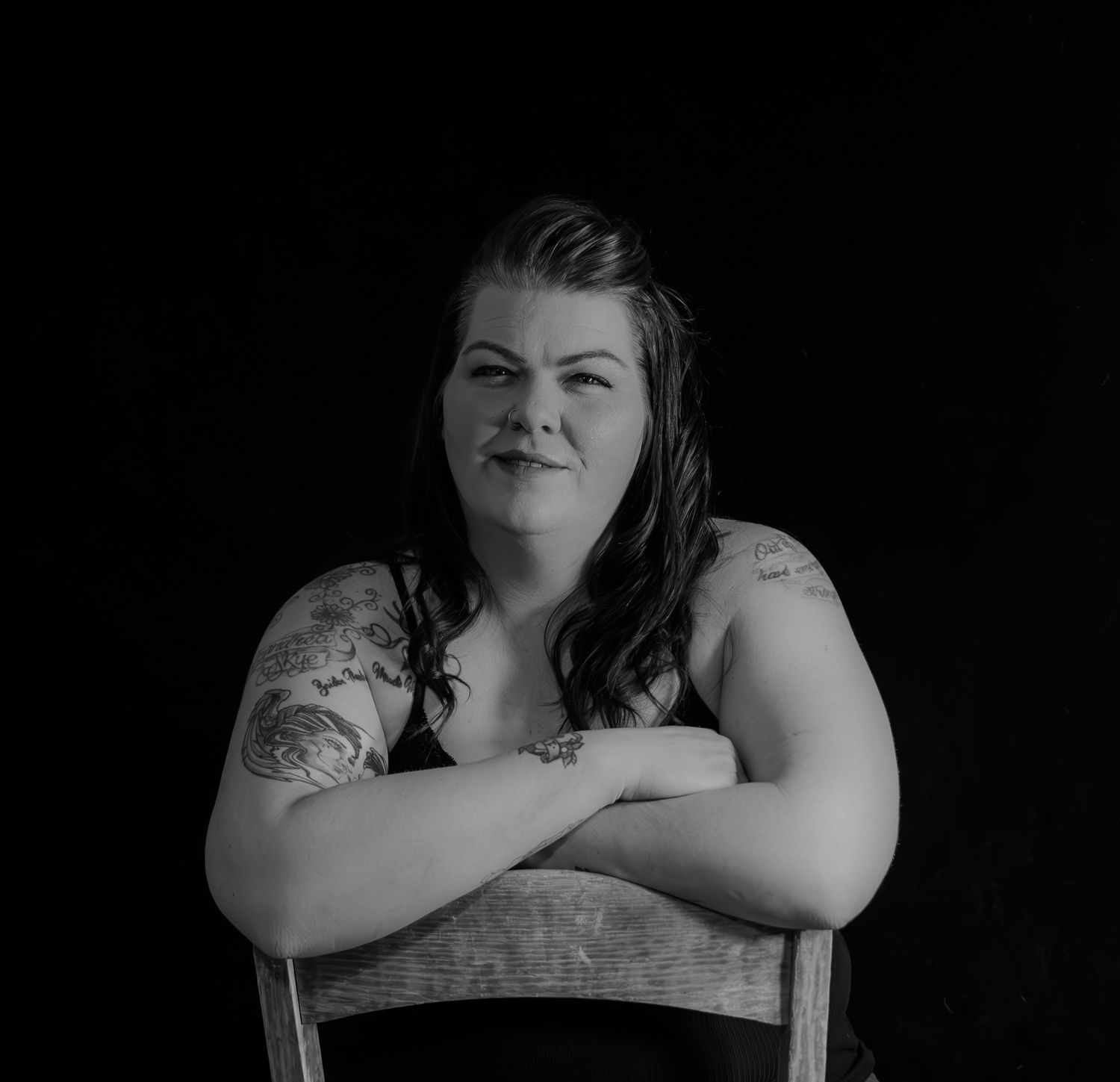 Artistic black and white portrait series showing a person posing in different positions against a dark background.