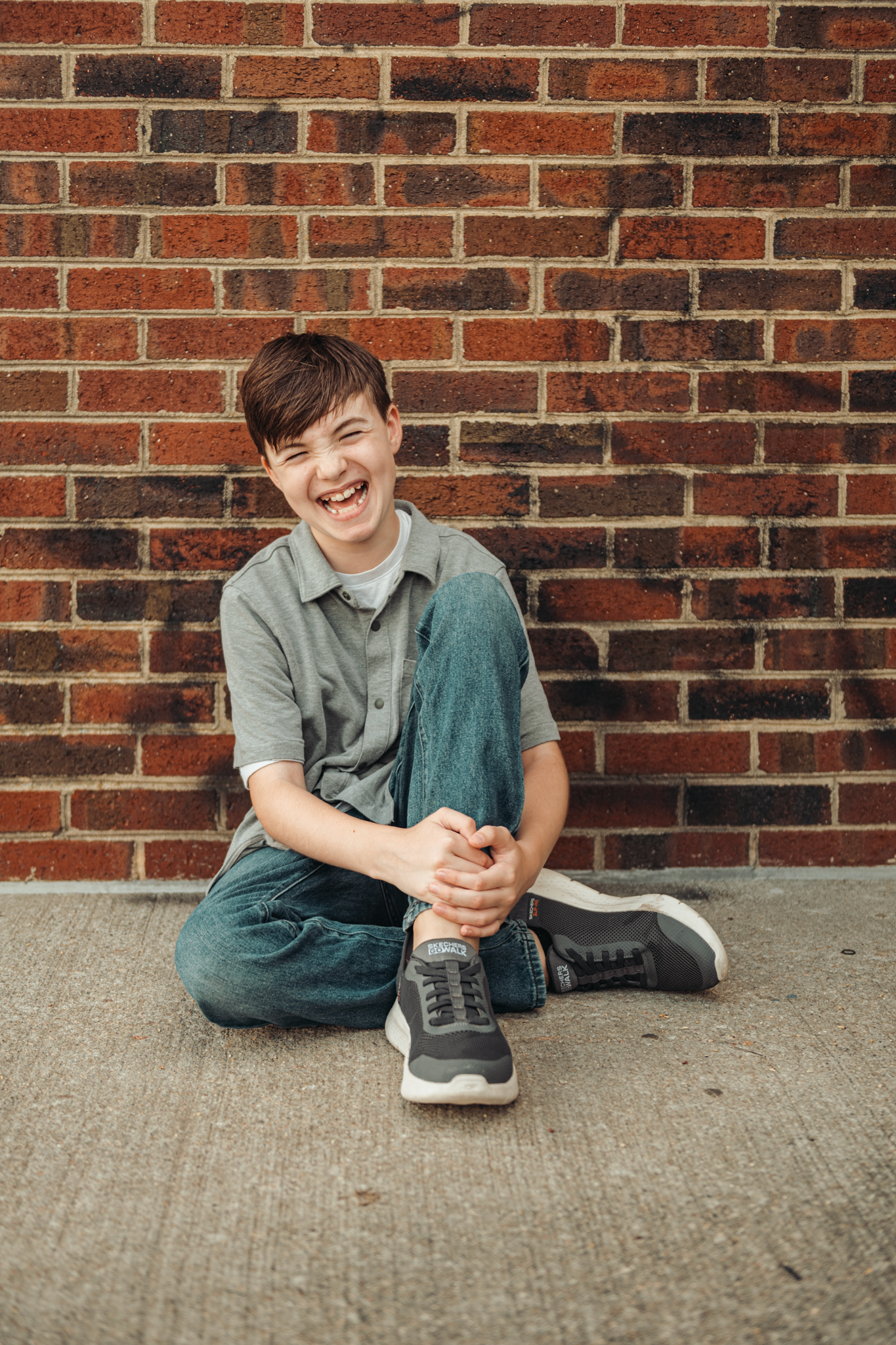 Three sequential photos of someone sitting and smiling against a brick wall while wearing casual clothes.
