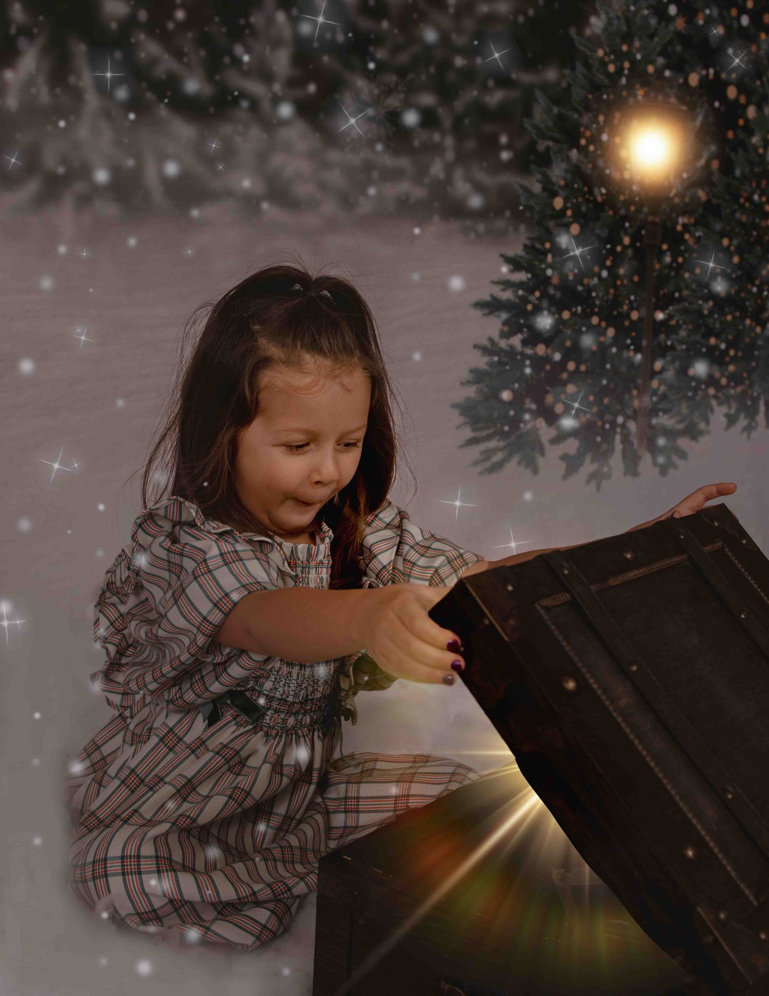 A child in plaid pajamas opens a glowing magical treasure box with sparkles and a bright light beam in a dreamy scene.
