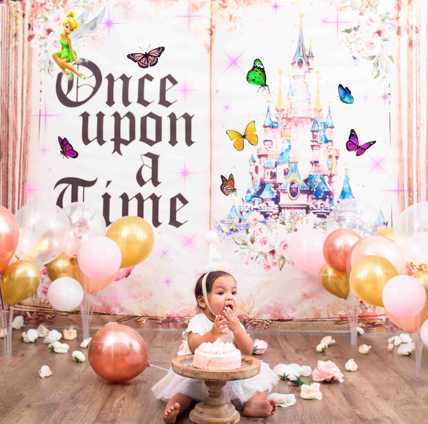 Pink cake smash setup with 'Once Upon a Time' backdrop, fairytale castle, floating butterflies and colorful balloons in Smithfield, NC