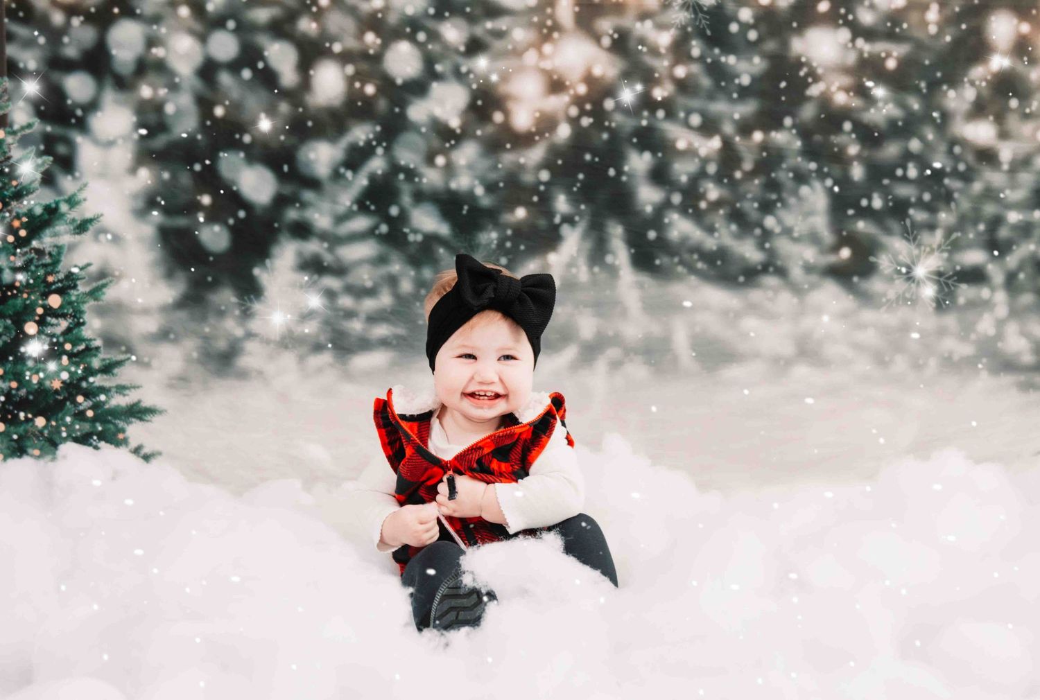 A small figure in a red outfit and black cat ear headband sits in snowy winter scene with bokeh lights and snowfall effects.