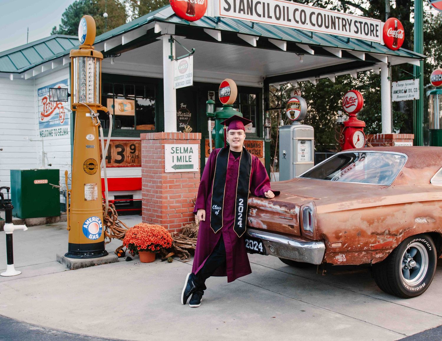 High school graduate leaning against classic car at a vintage service station by Krystie Nicole Photo in Smithfield, NC