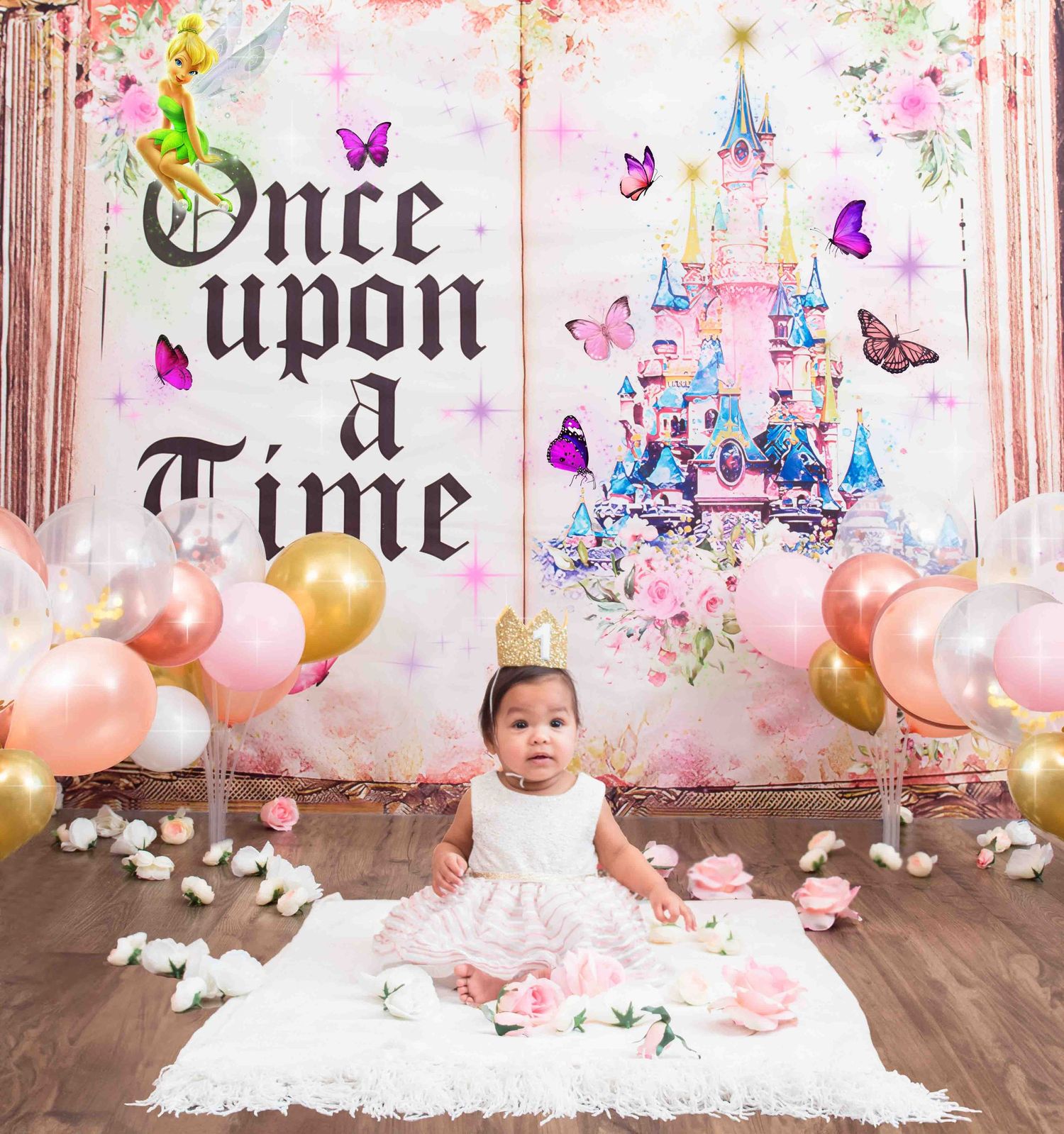 Whimsical Once Upon a Time themed party setup with castle backdrop, floating butterflies and pink balloons.